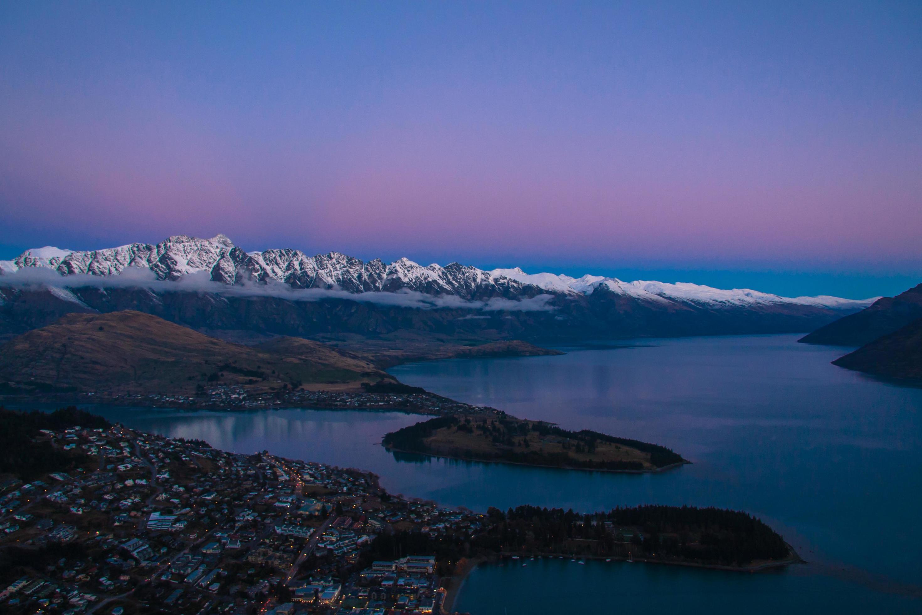 Sunset over river and snowcapped mountains Stock Free