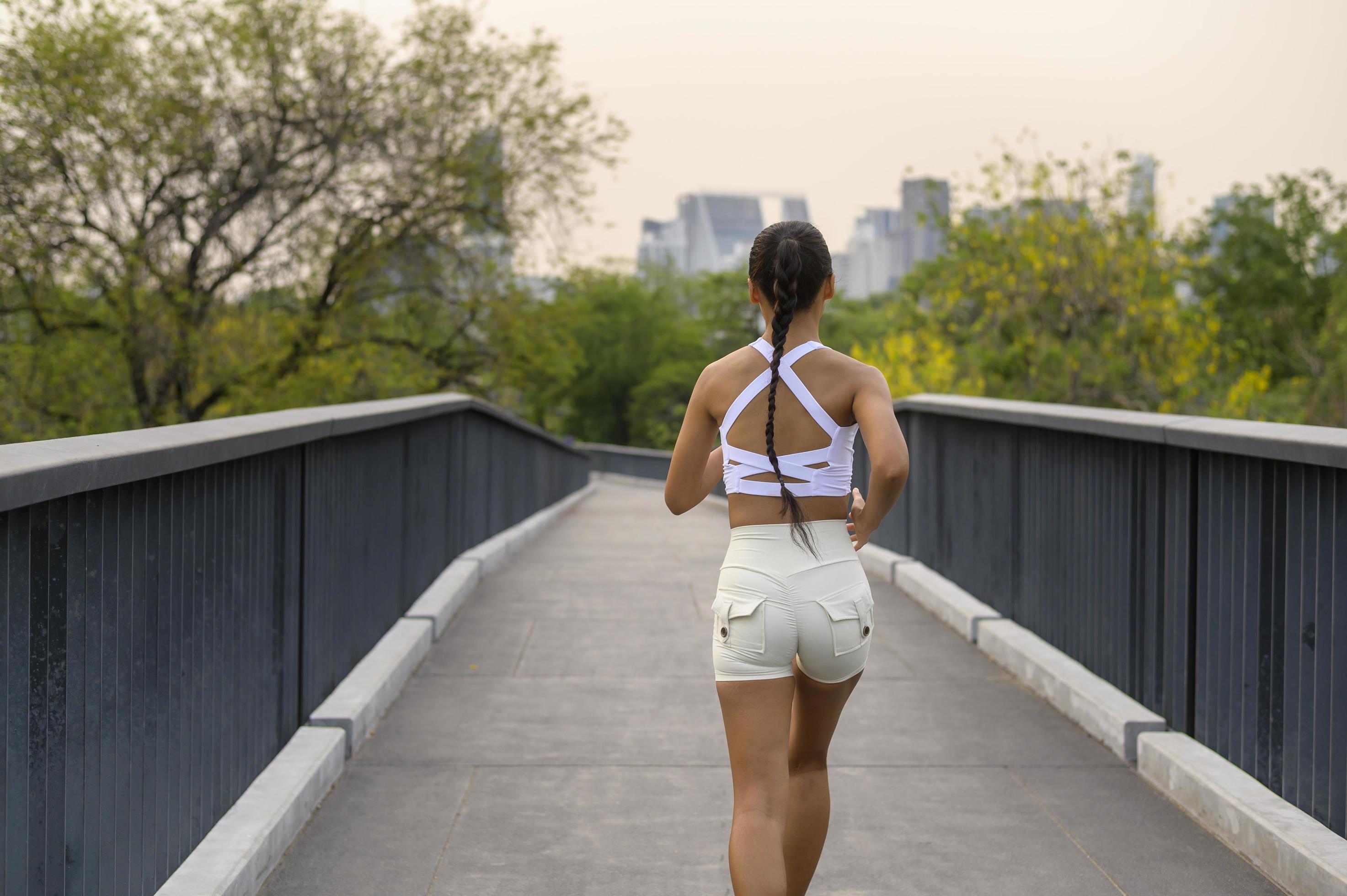 Young fitness woman in sportswear jogging in city park, Healthy and Lifestyles. Stock Free