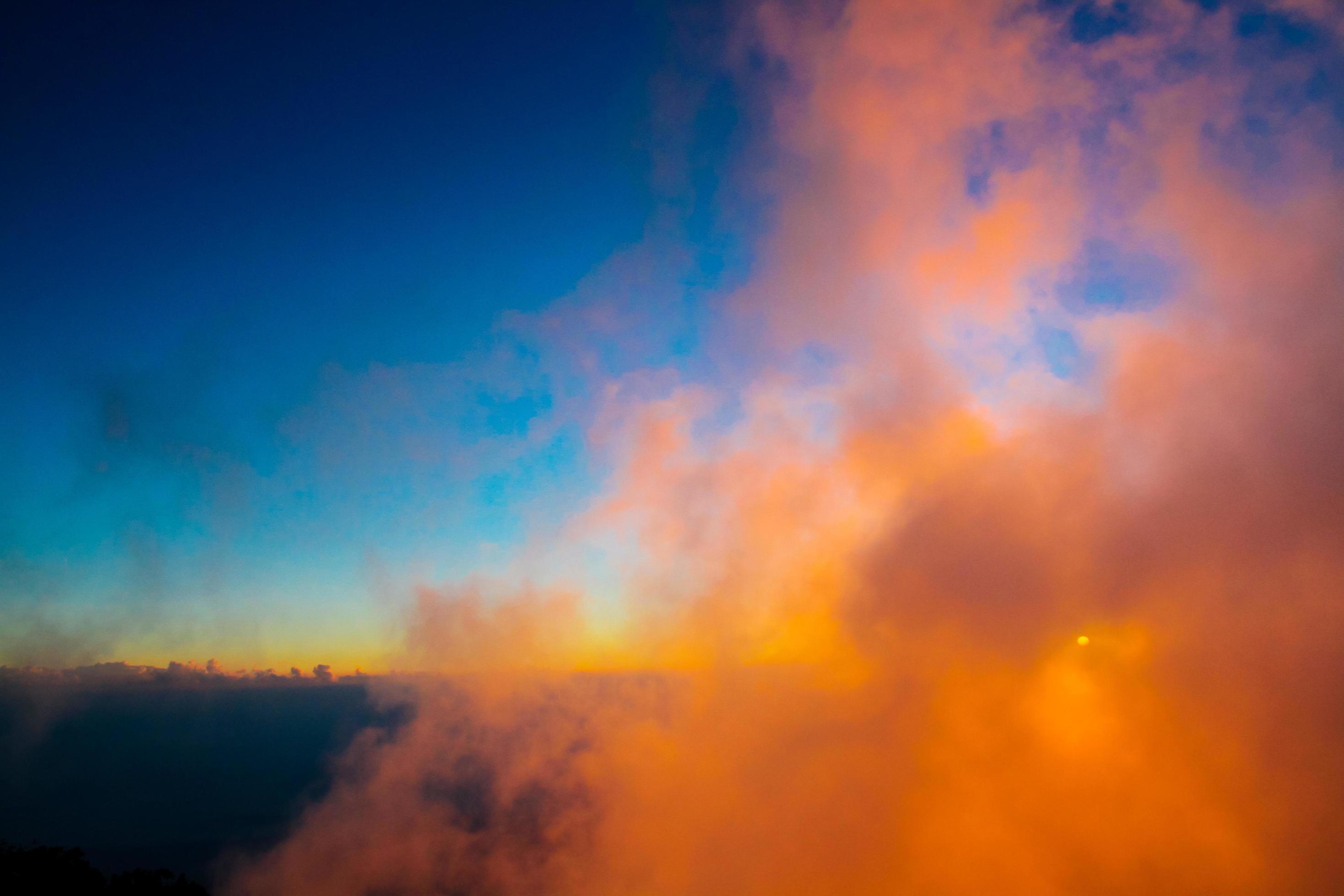 Sunset in sky and cloud, beautiful colorful twilight time with silhouette of mountain. Stock Free