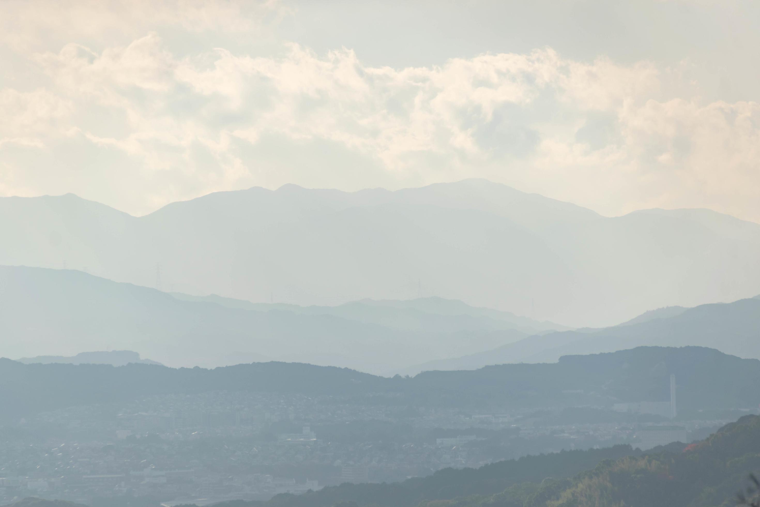 Aerial view of misty mountains at Layers of mountains with sunshine, natural environment Stock Free