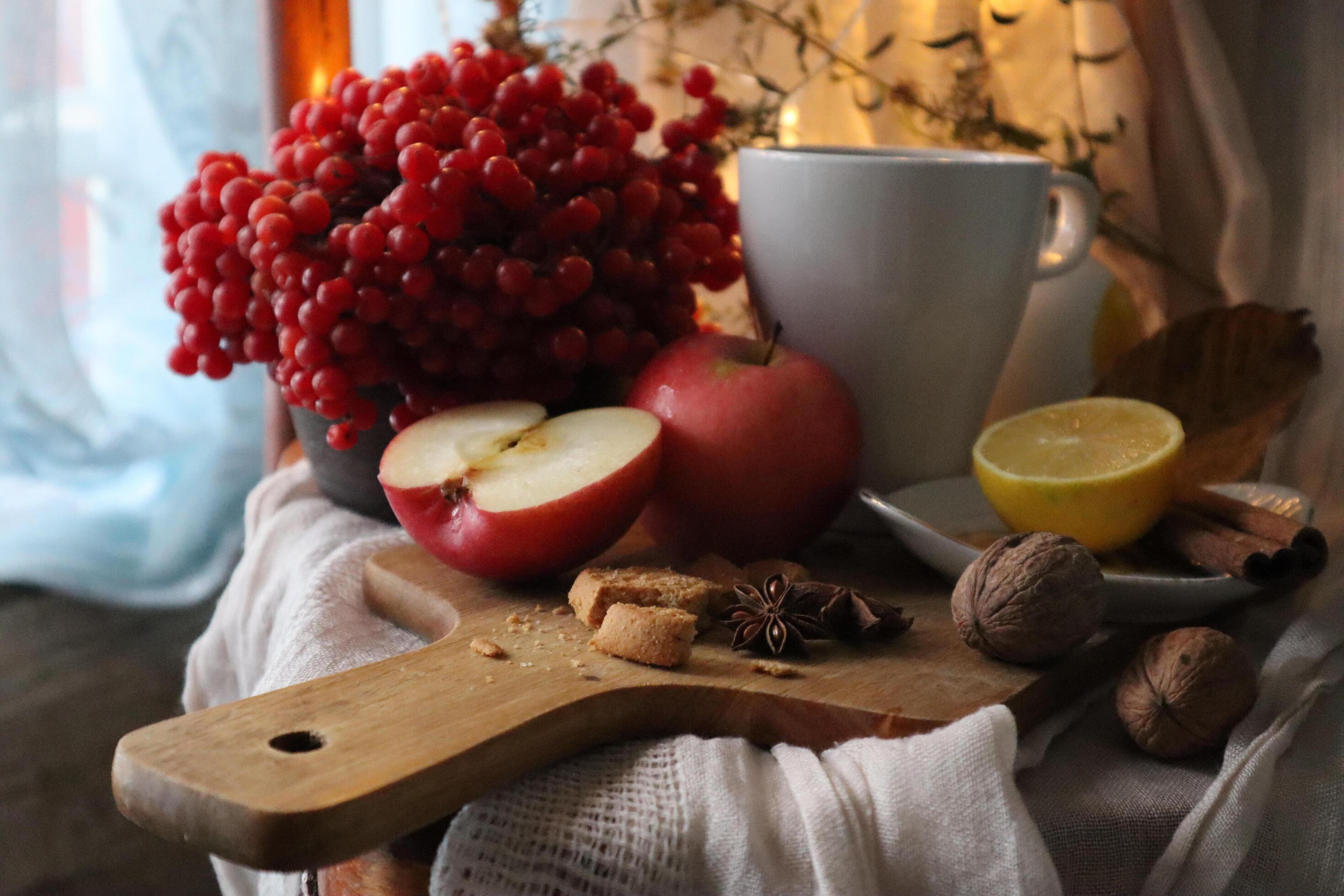 Autumn food photography composition Red apples, viburnum berries on a wooden cutting board Stock Free