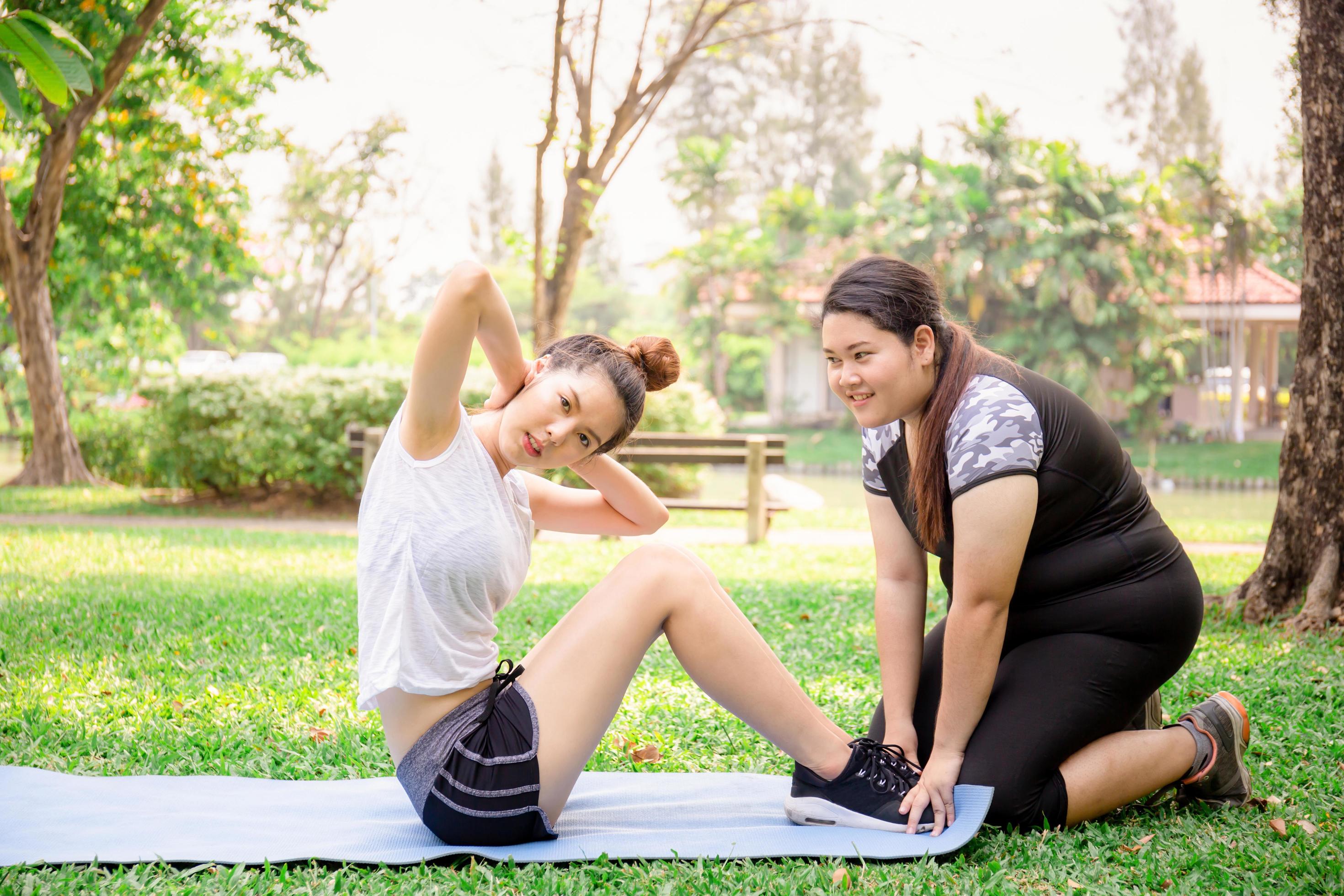 Young women and friend exercising in the park, healthy and lifestyle concept Stock Free