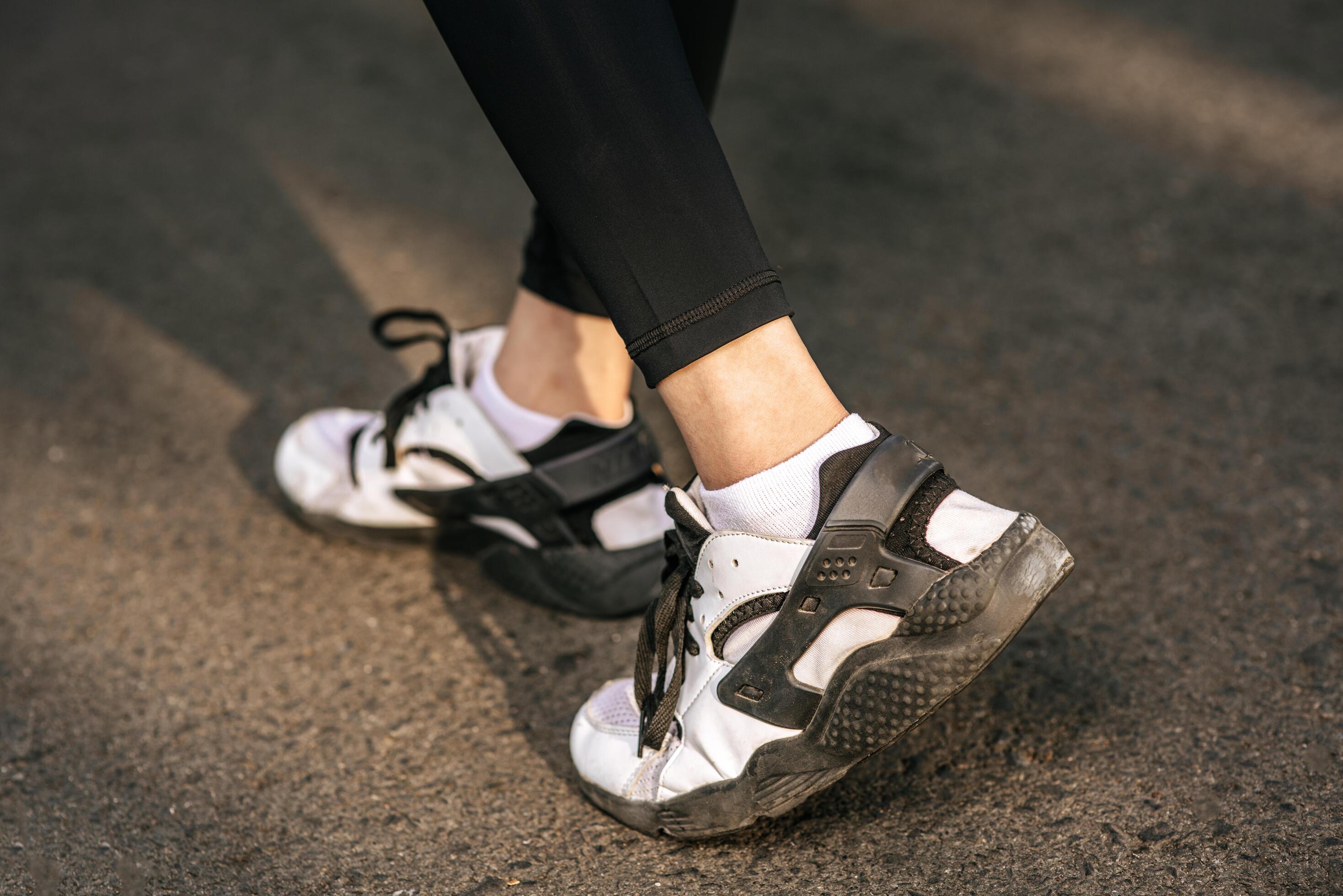 Runner woman feet running on road closeup on shoe. Sports healthy lifestyle concept. Stock Free