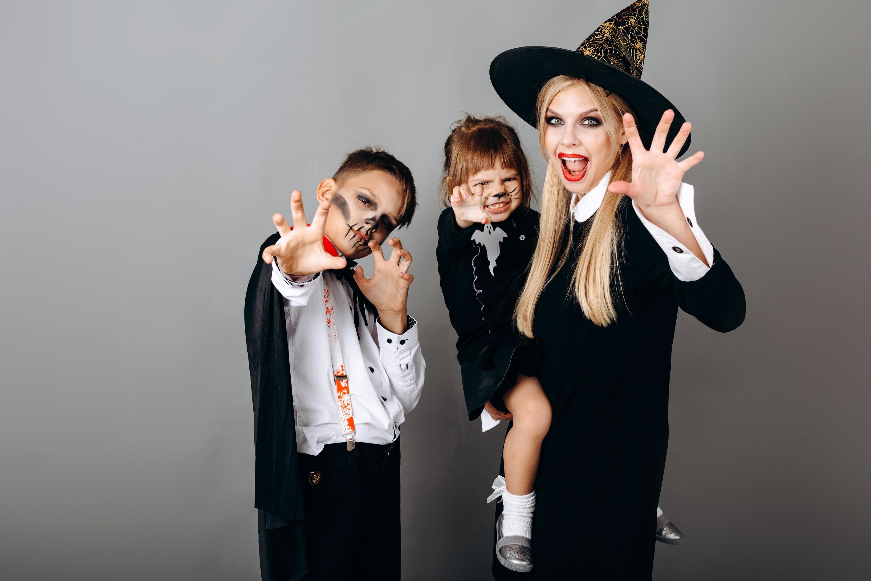 Family in fancy dress showing scary gesture looking at the camera.- Image Stock Free