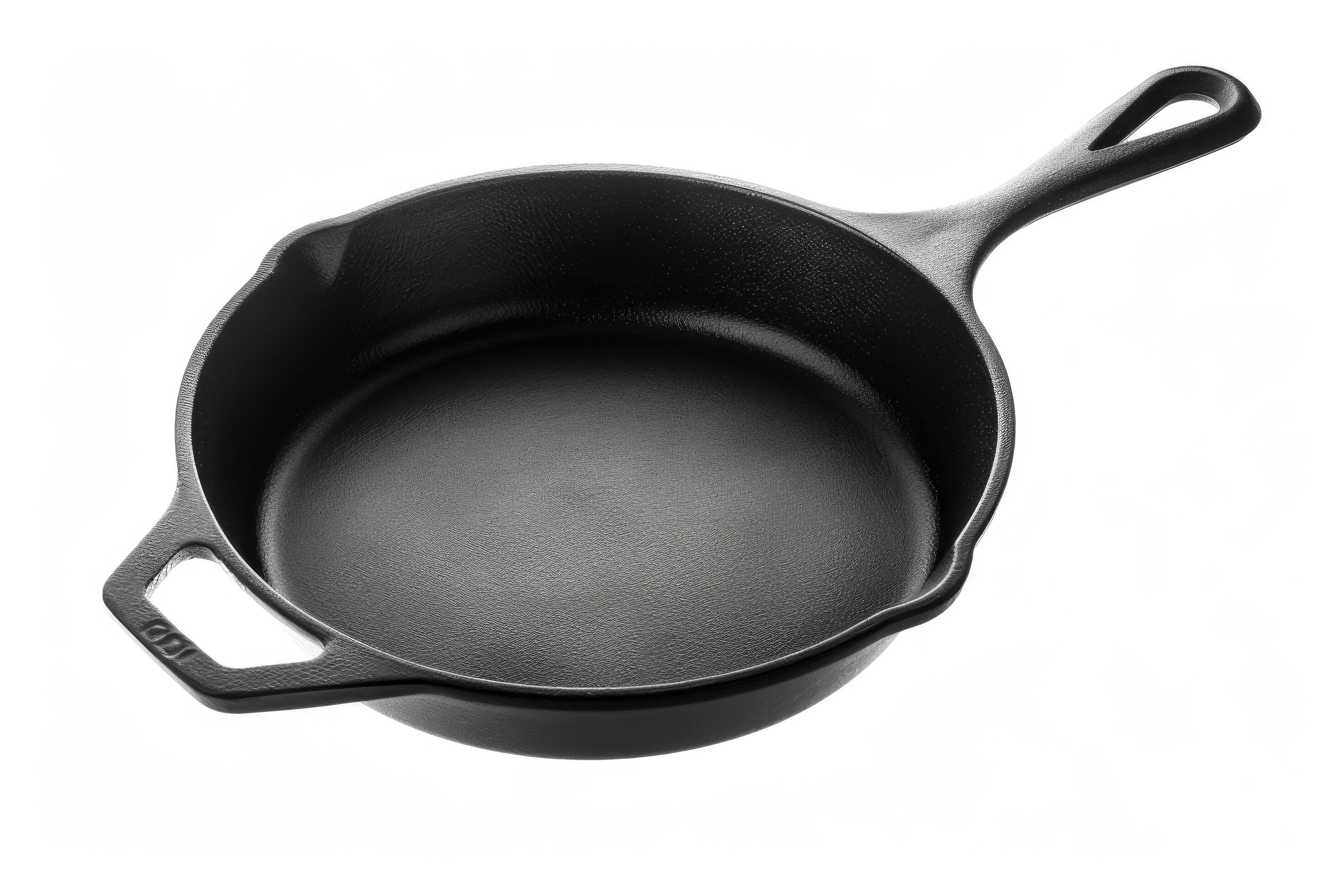 Black cast iron skillet on a white background. Stock Free