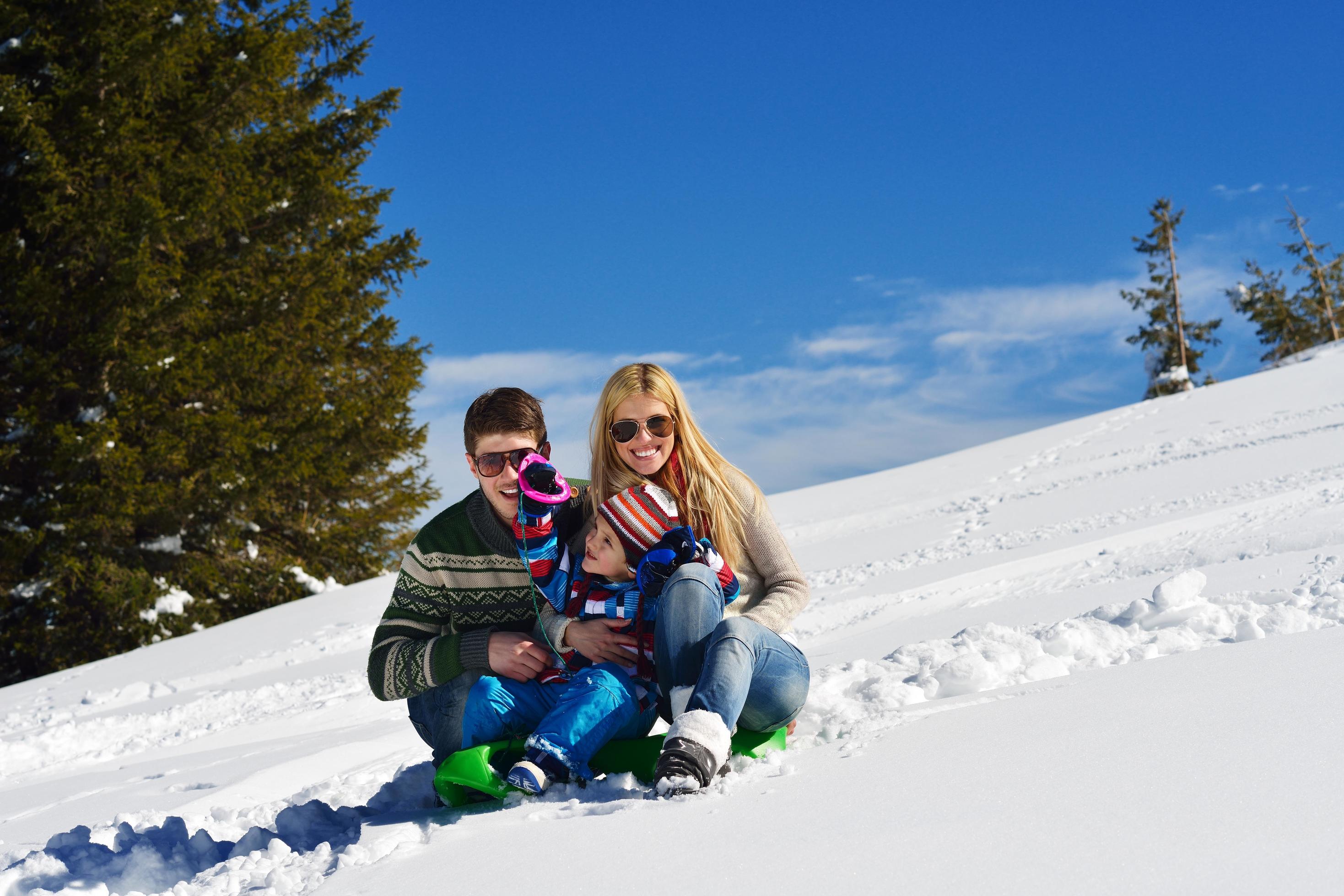 family having fun on fresh snow at winter Stock Free