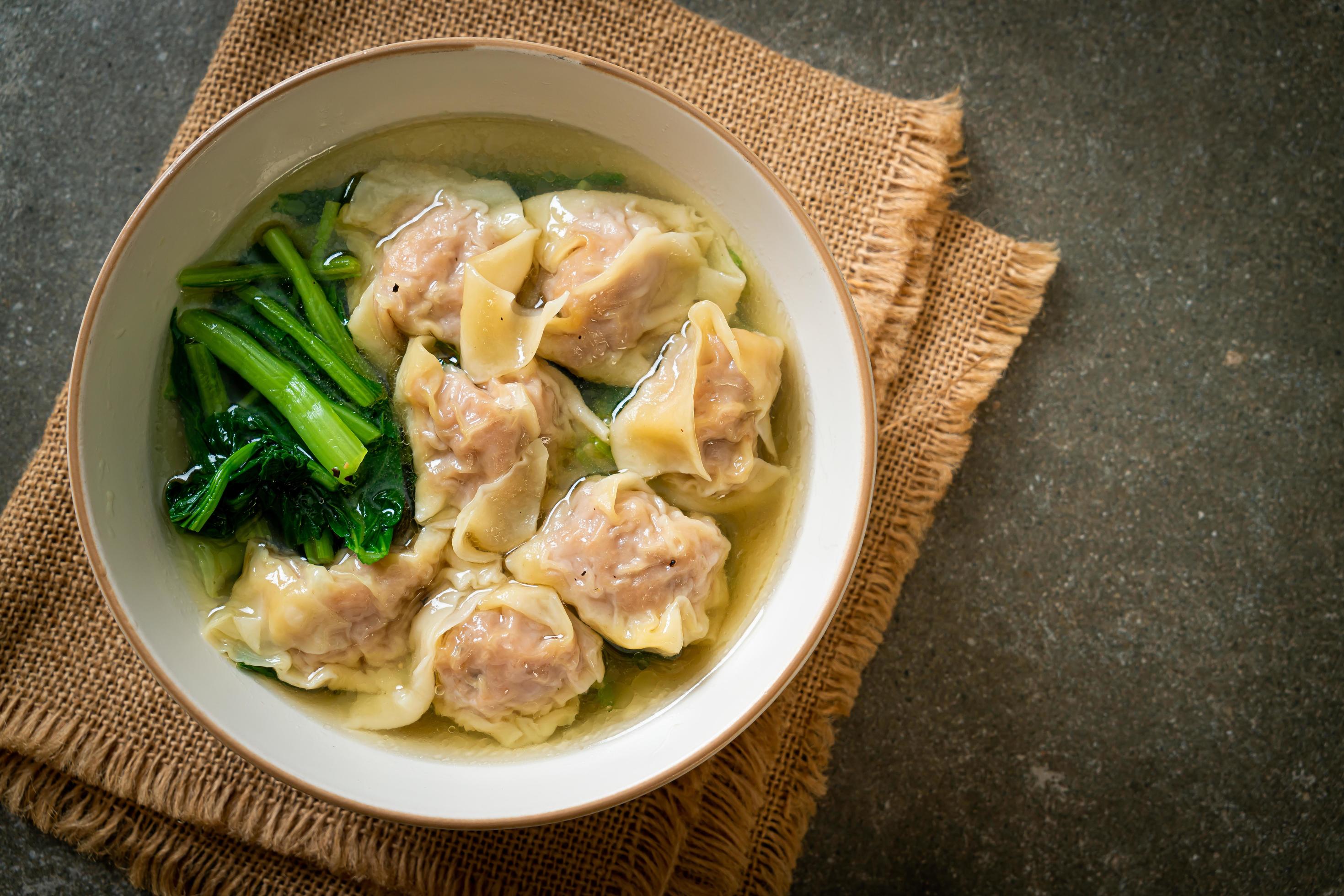 Pork wonton soup or pork dumpling soup with vegetables – Asian food style Stock Free