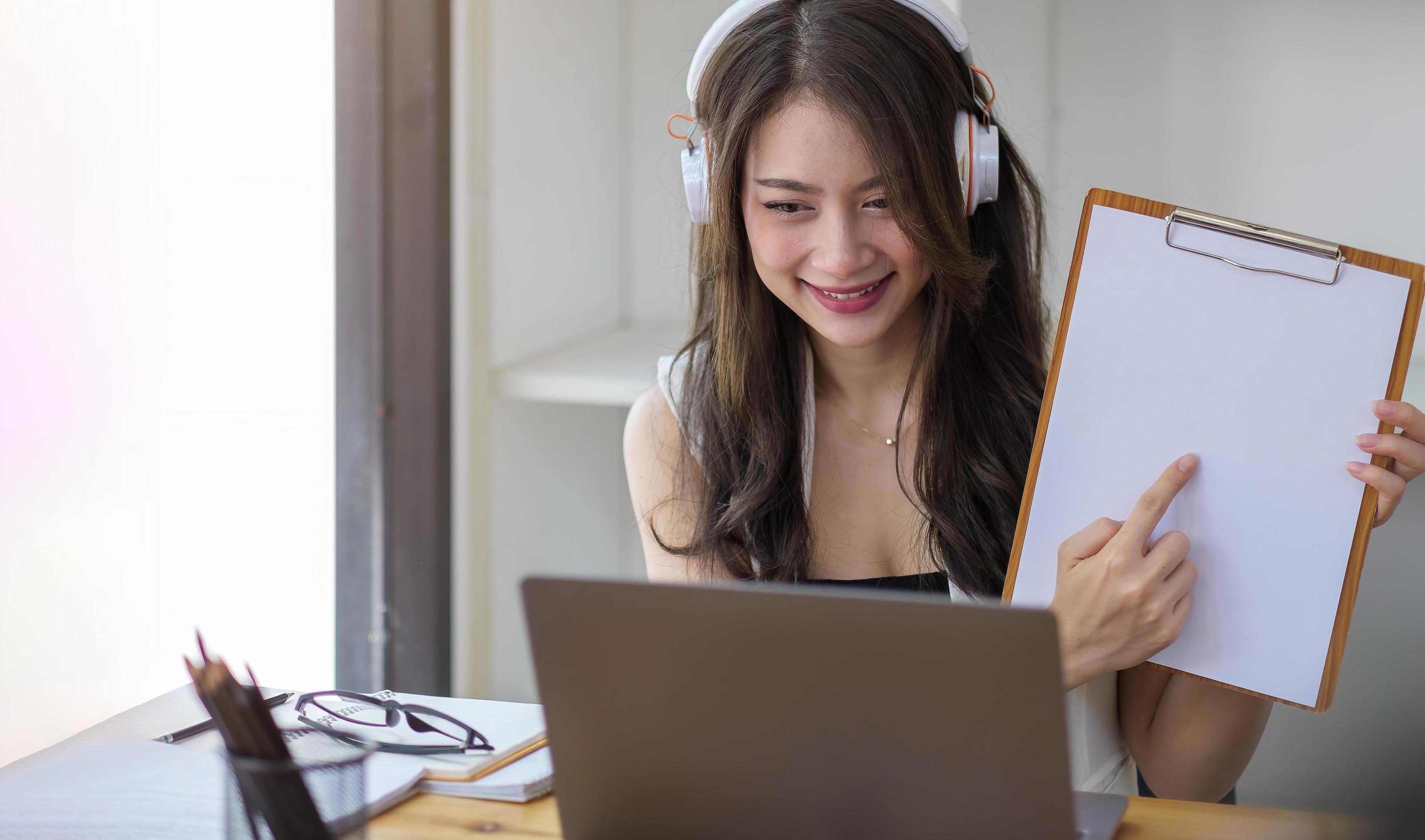 
									Portrait of attractive Asian woman looking at camera smiling with confidence working with smart tablet and positive lifestyle concept at the cafe Stock Free