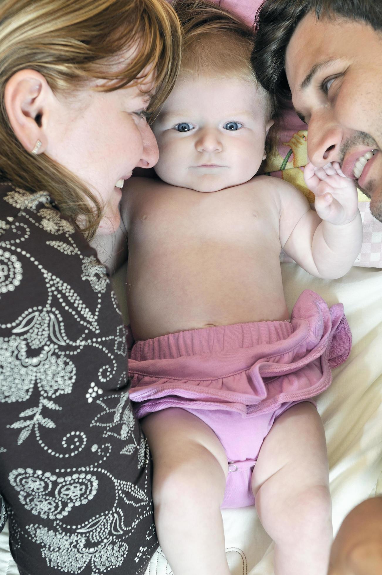 portrait of young family with cute little babby Stock Free