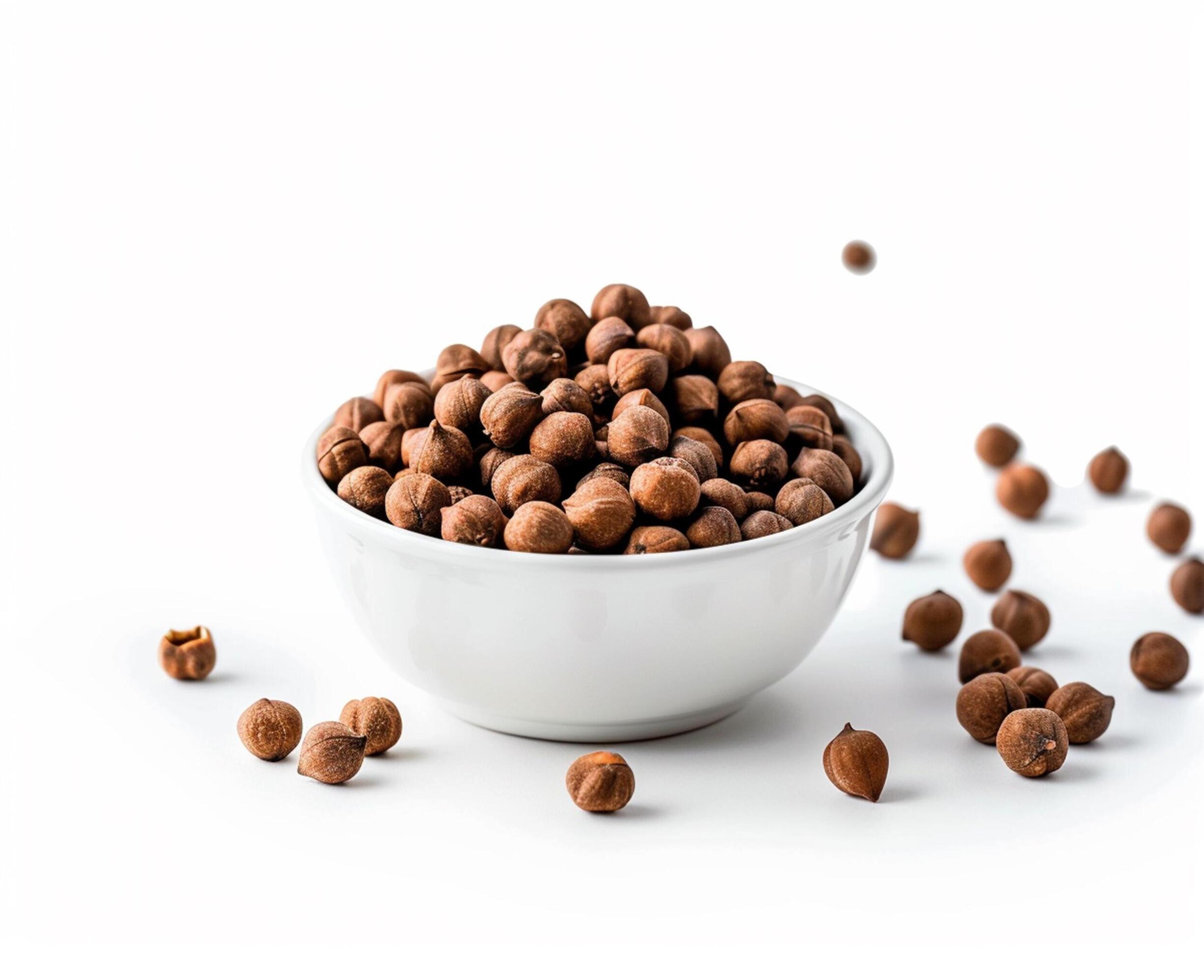 a bowl full of nuts on a white background Stock Free