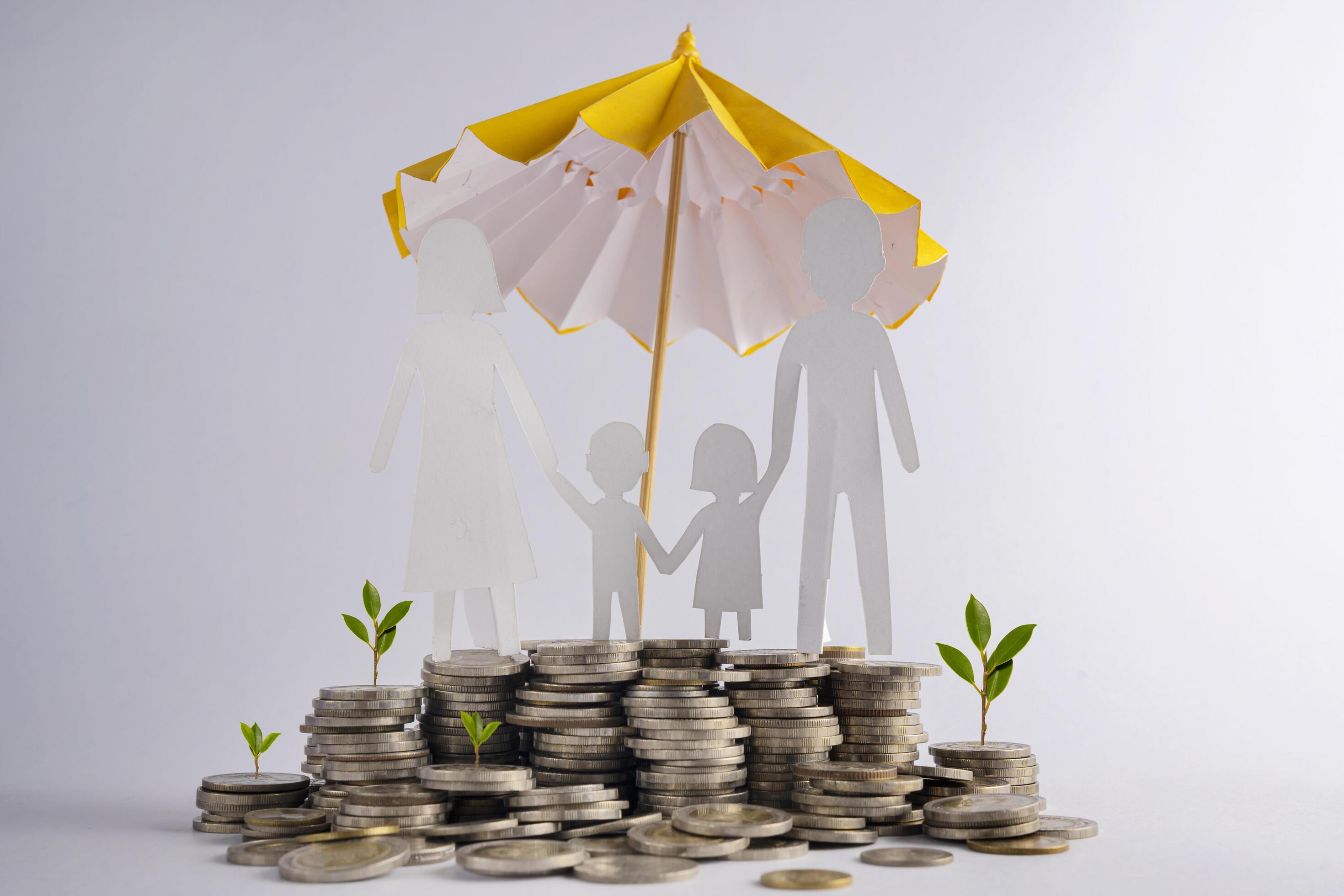 Stack of coins with family with protective umbrella on dark background, business idea and savings insurance concept. Stock Free