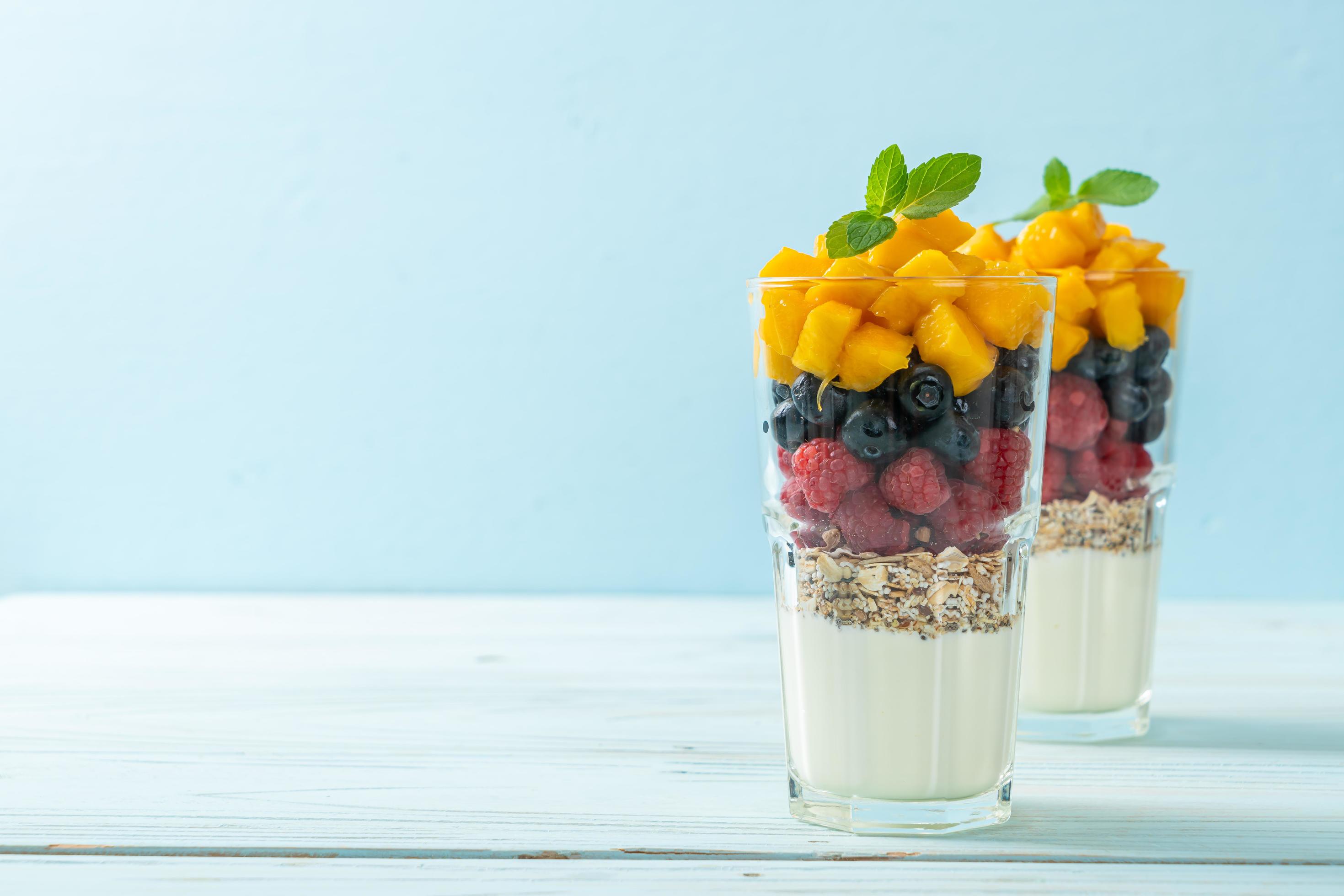 Homemade mango, raspberry, and blueberry with yogurt and granola – healthy food style Stock Free