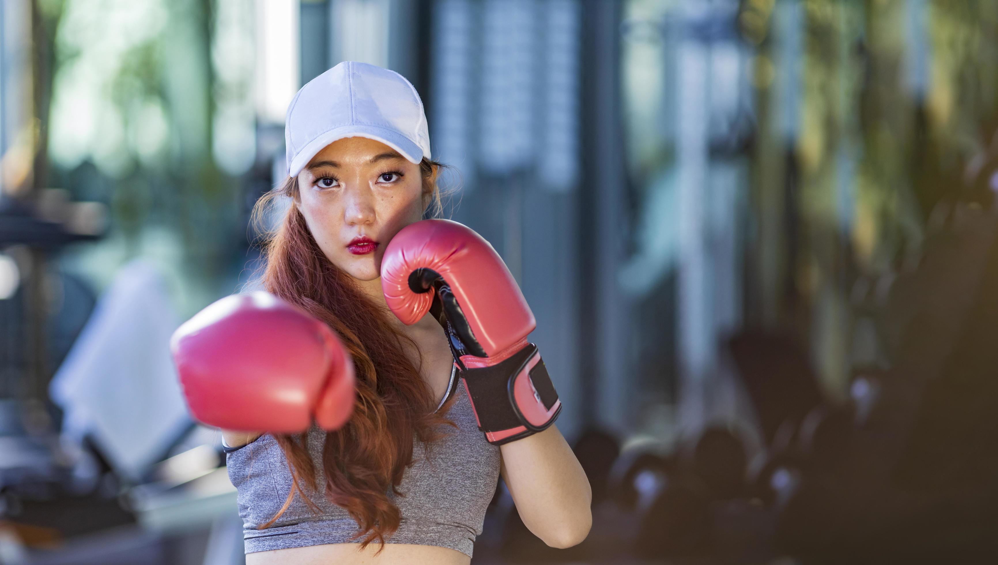 Asian woman have boxing exercise in the gym for fitness and healthy lifestyle with copy space Stock Free