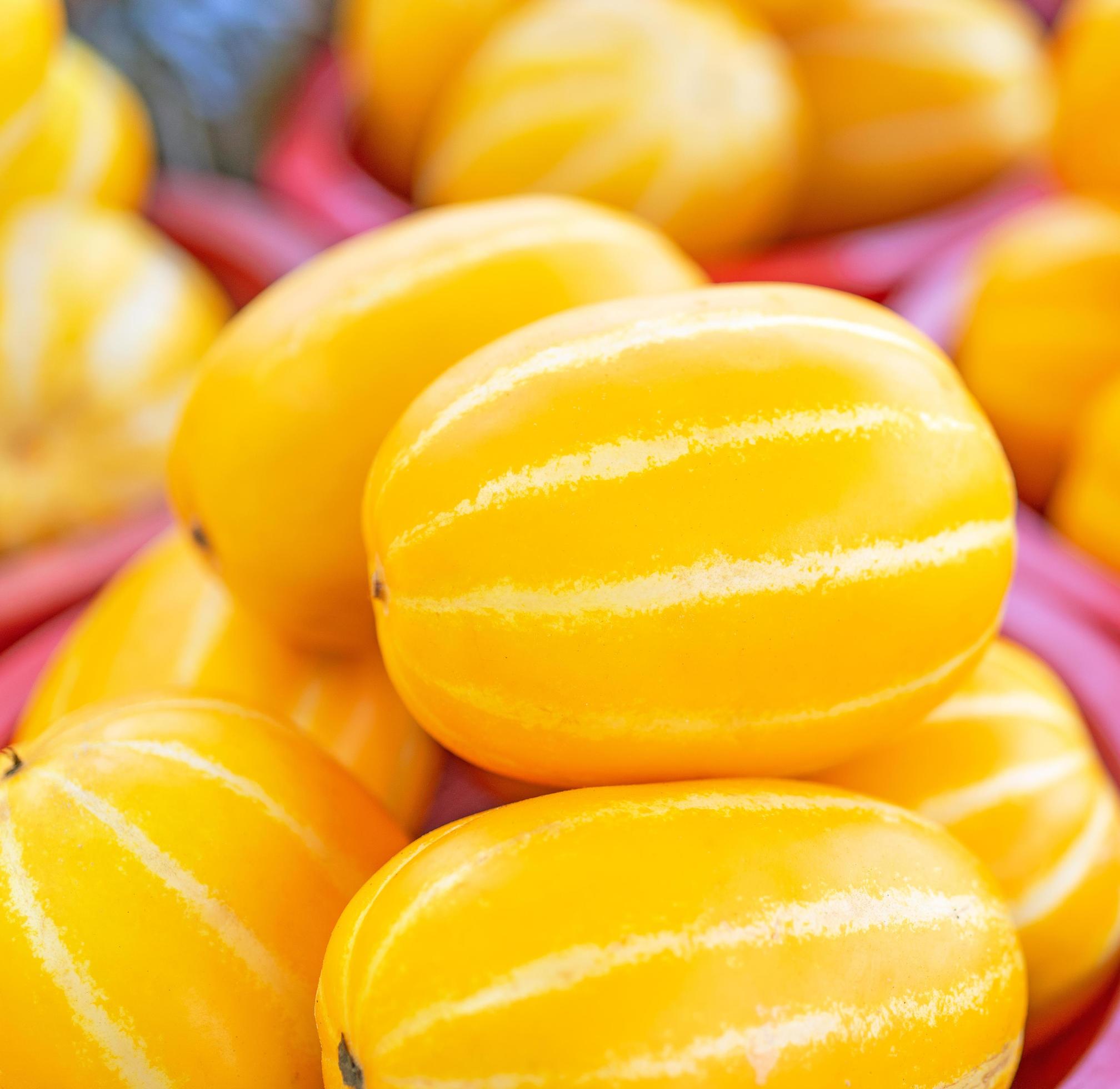 Delicious korean stripe yellow melon fruit food in red plastic basket at tradition market afternoon, Seoul, South Korea, harvest concept, close up. Stock Free