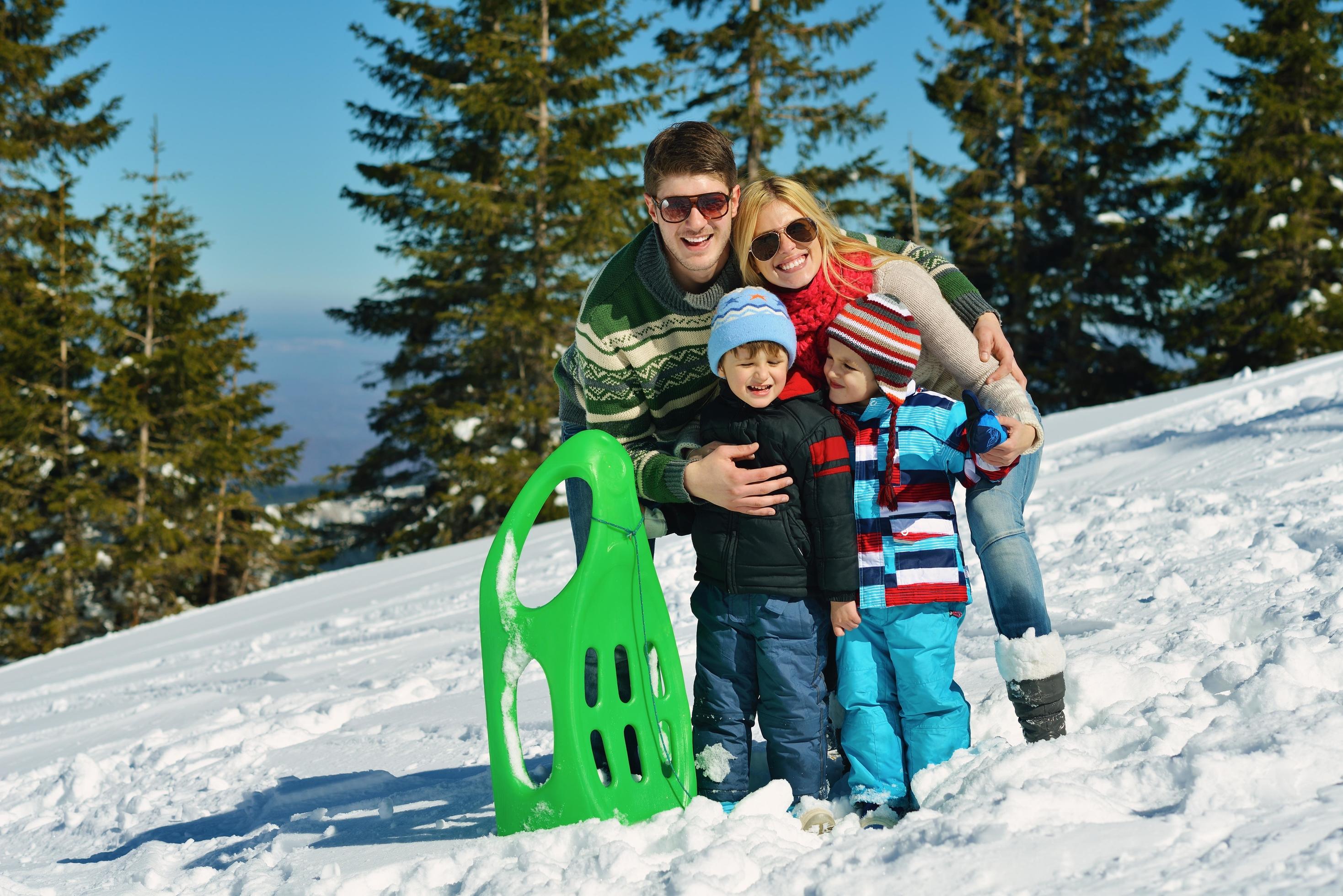 family having fun on fresh snow at winter Stock Free