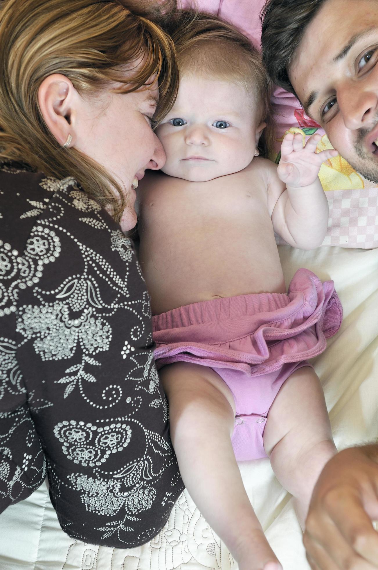 portrait of young family with cute little babby Stock Free