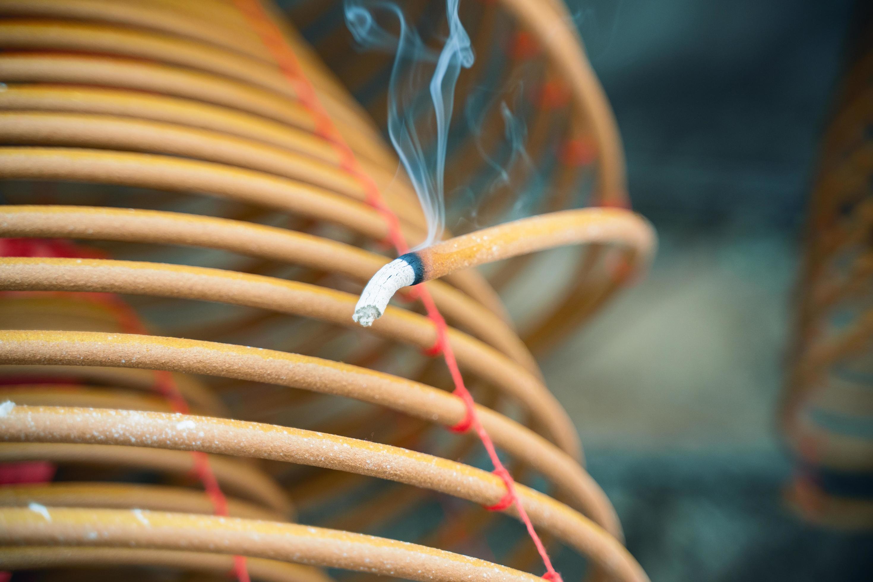 Burned coil swirl incense in Macau Macao temple, traditional Chinese cultural customs to worship god, close up, lifestyle. Stock Free