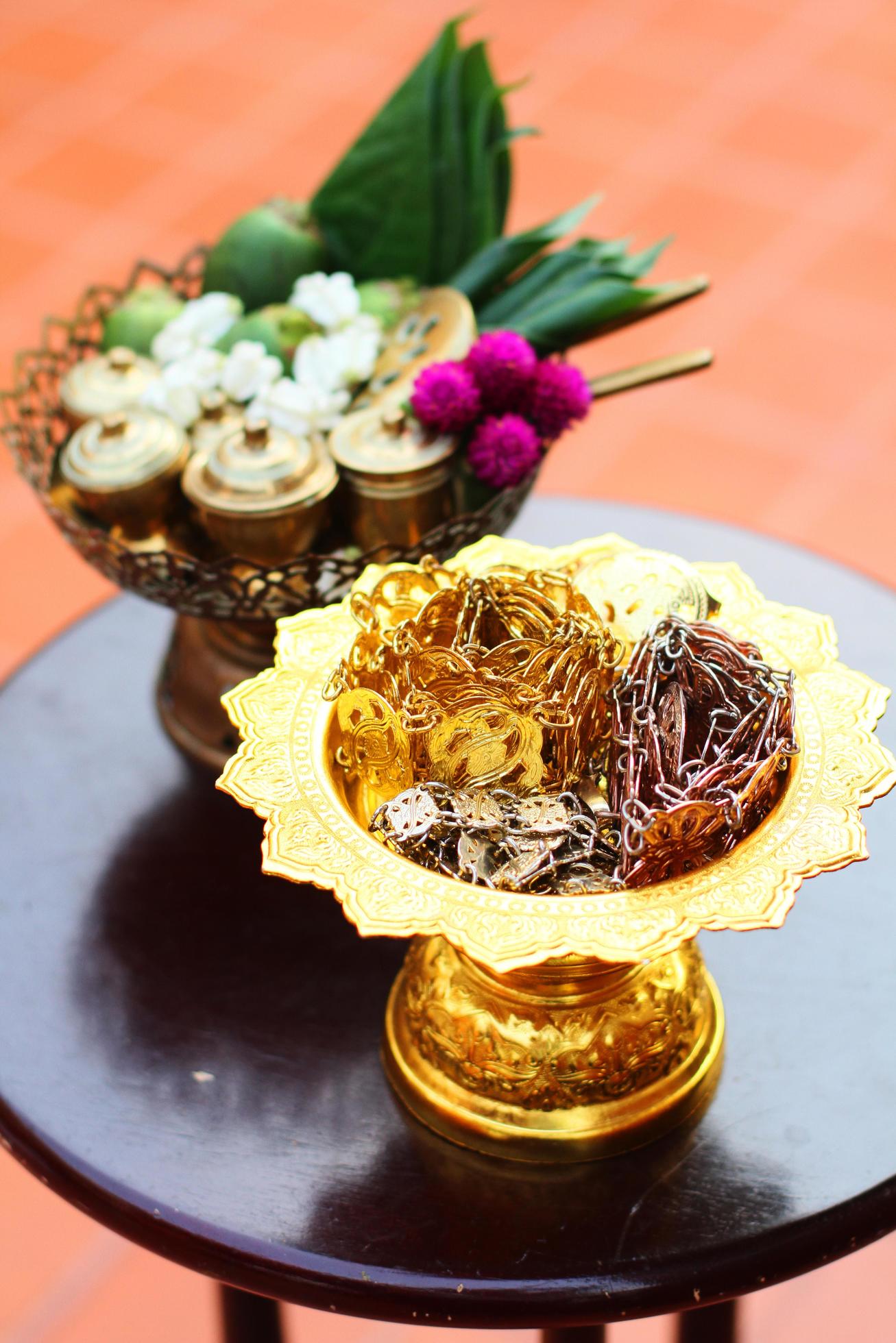 Silver and Gold Thai accessory, Green betel nuts and Marigold flowers on golden tray for Wedding ceremony in Thailand traditional Stock Free