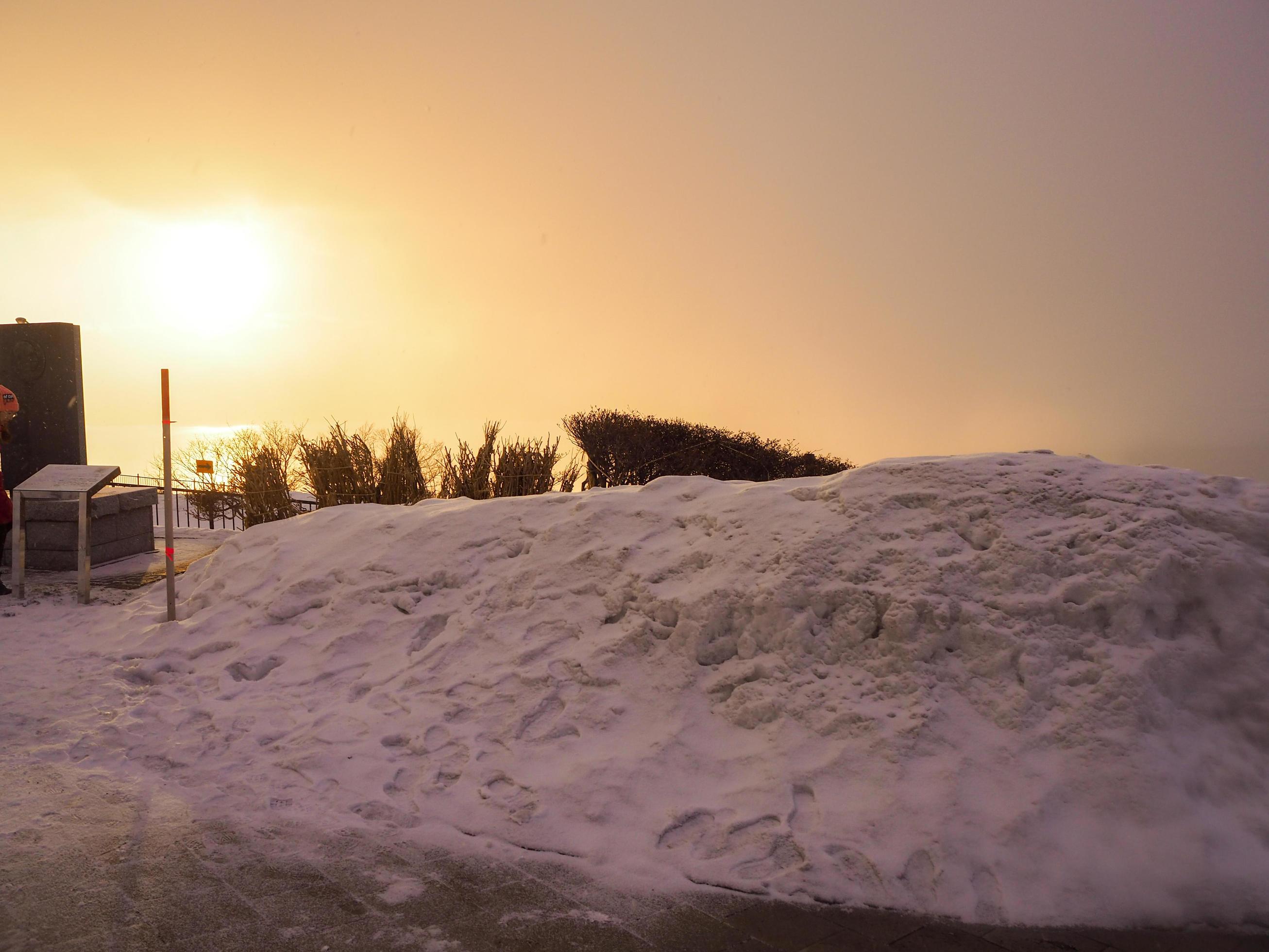 Visitors to collect sunrise is a natural sun in the winter with snow on the mountain. Stock Free