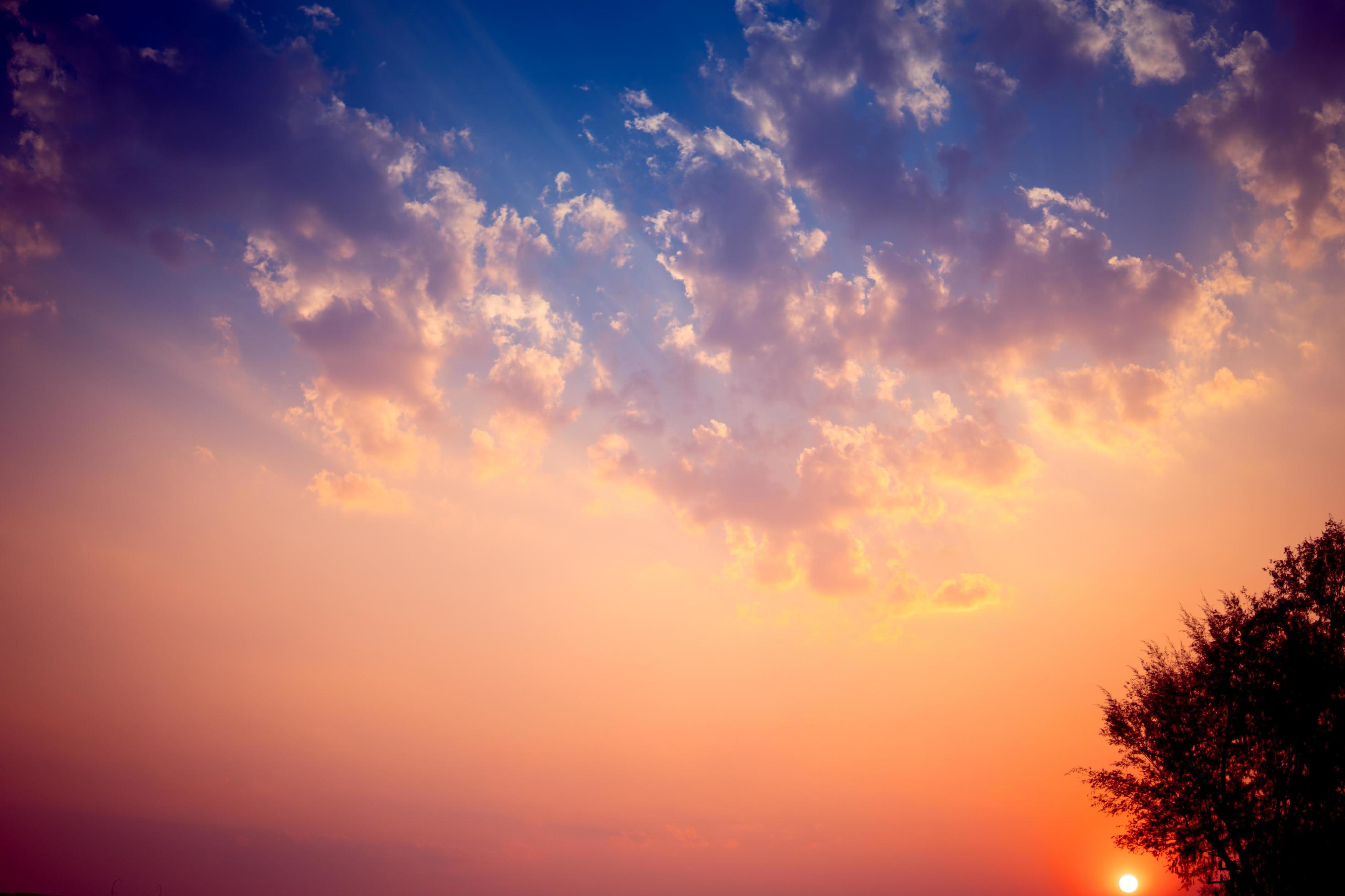 Sunset background with wonderful golden yellow sky.Dusk sky in the evening,amazing dramatic and wonderful cloud at twilight. Stock Free