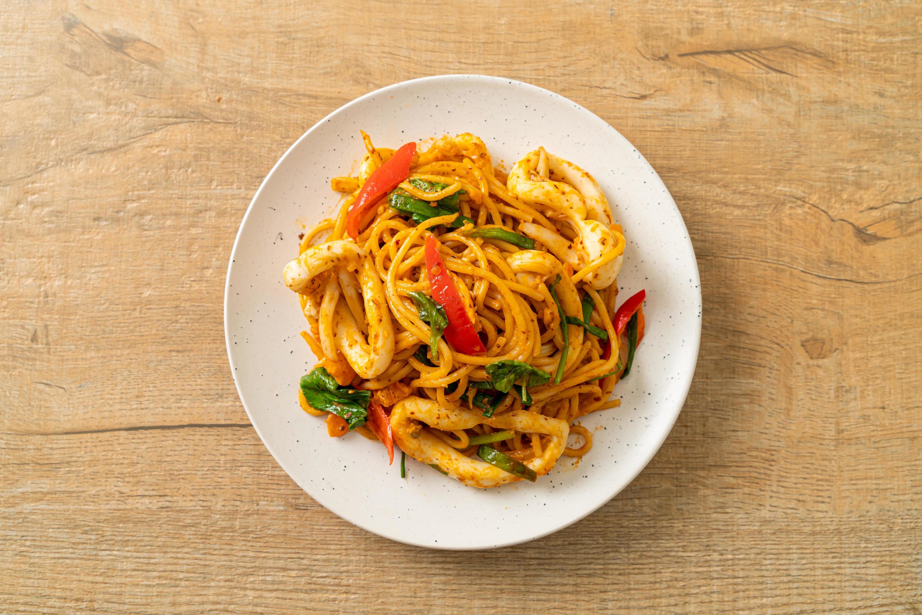 Stir-fried spaghetti with salted egg and squid – fusion food style Stock Free