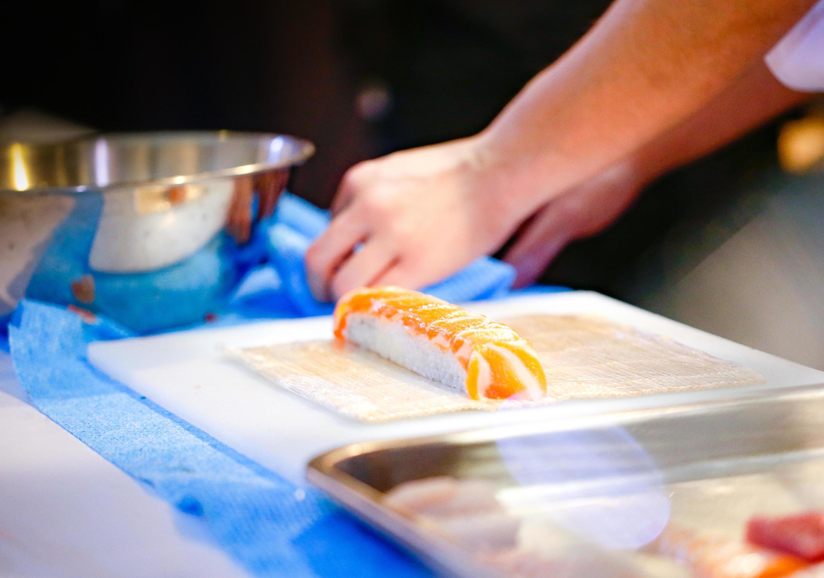 chef hands preparing japanese food, chef making sushi Stock Free