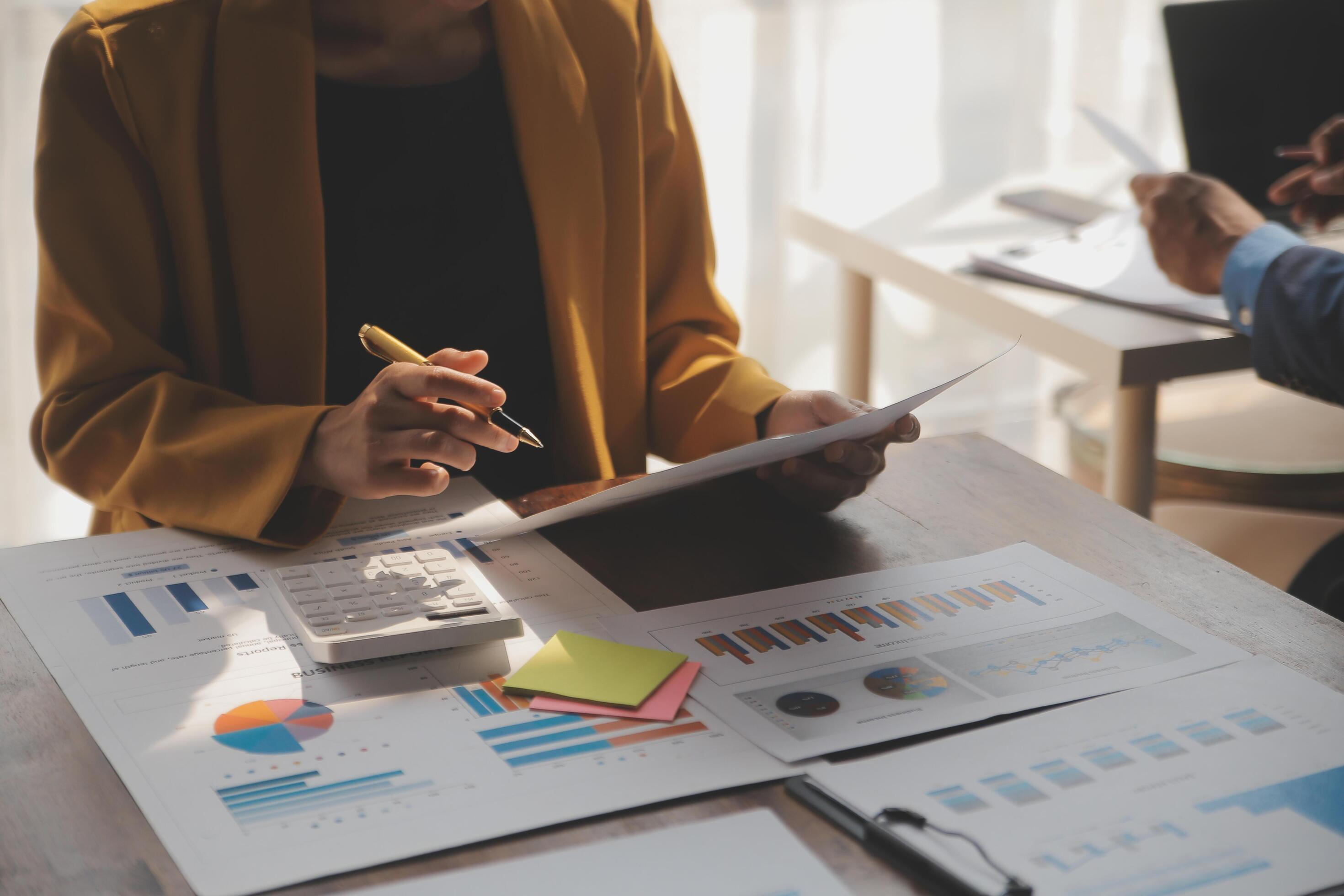 Close up of Business team analyzing income charts and graphs with modern laptop computer. Business analysis and strategy concept. Stock Free