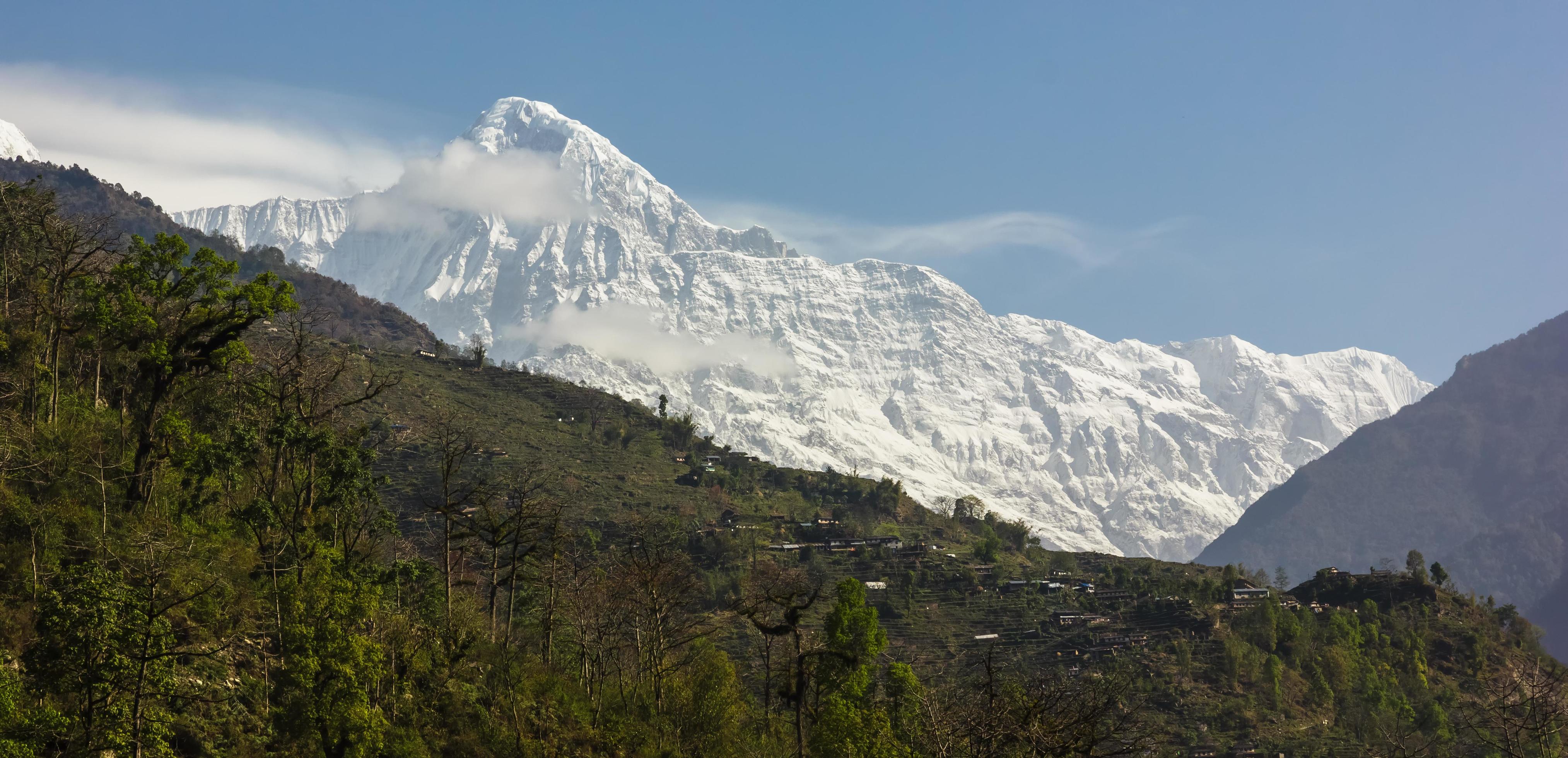 A view of the snow covered peak of Annapurna South from the trekking trail that goes to the Annapurna Base Camp. Stock Free