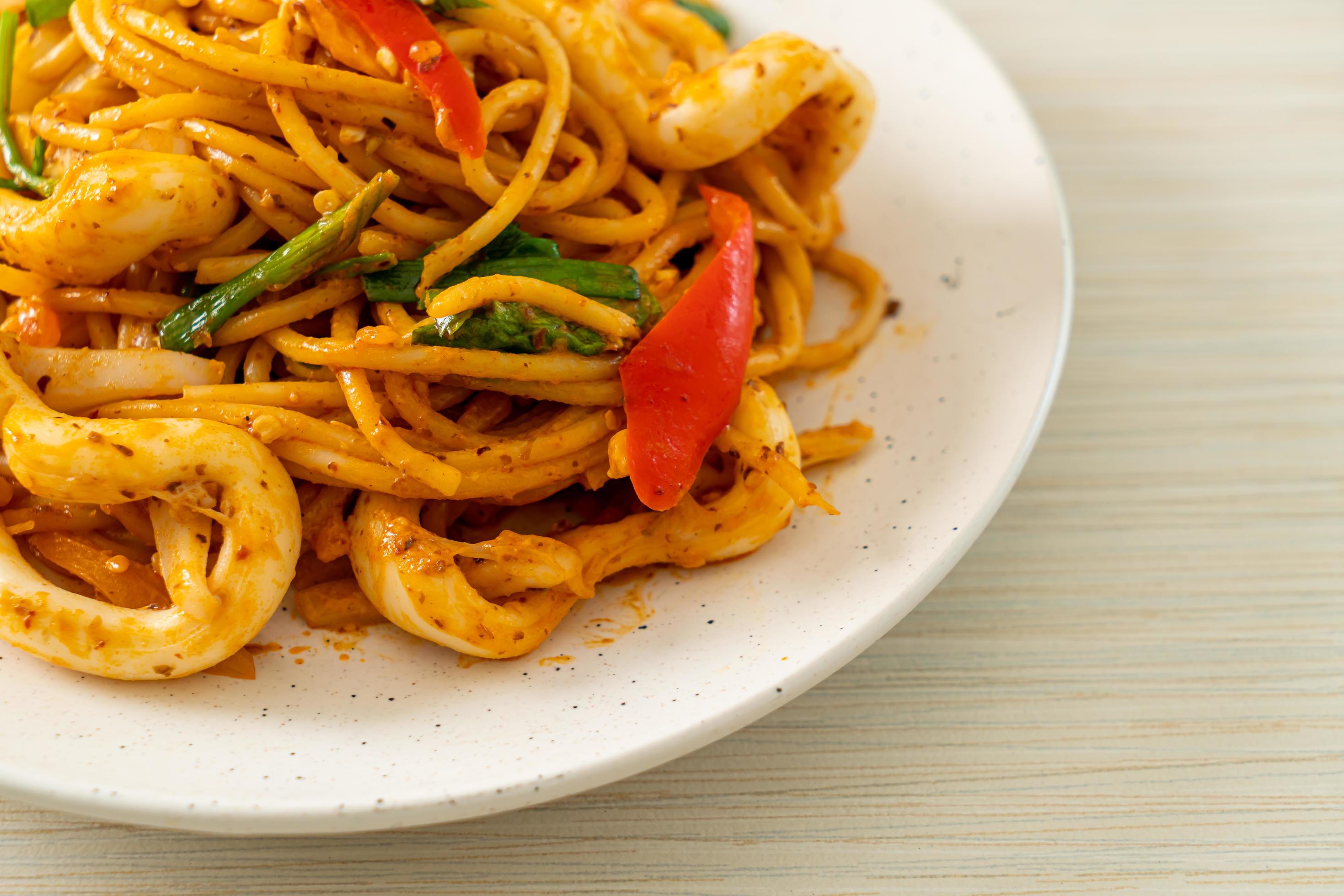 Stir-fried spaghetti with salted egg and squid – fusion food style Stock Free