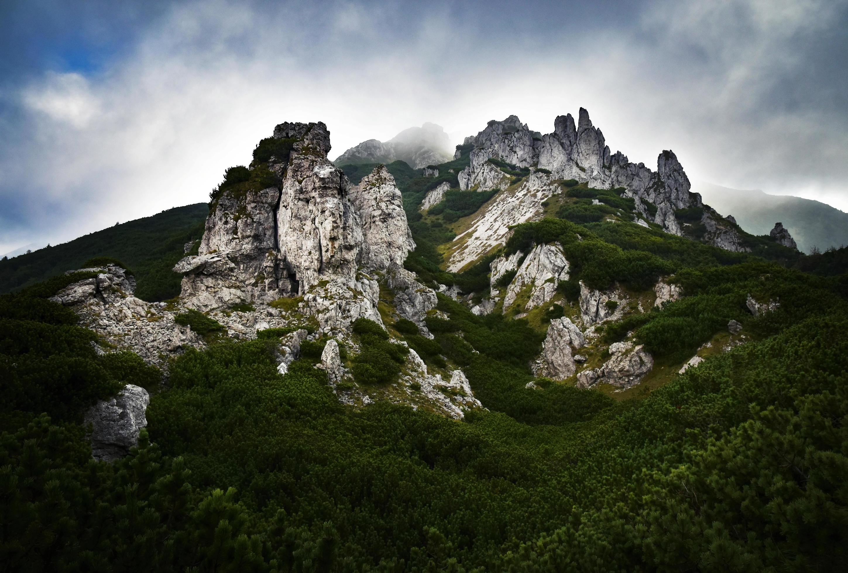 Rocky mountaintop with clouds Stock Free