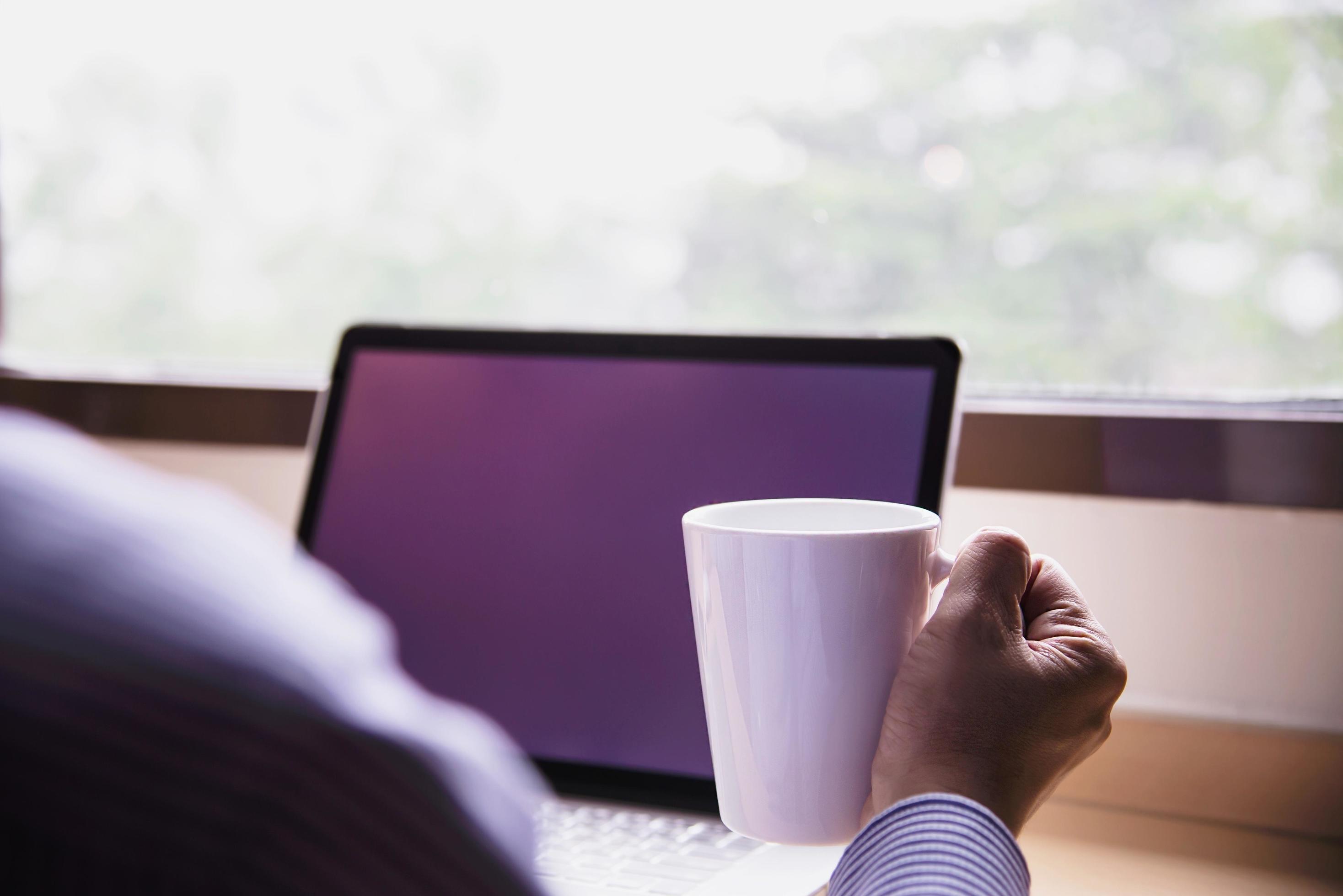 Businessman working with computer with coffee cup in the hotel room – people working lifestyle concept Stock Free