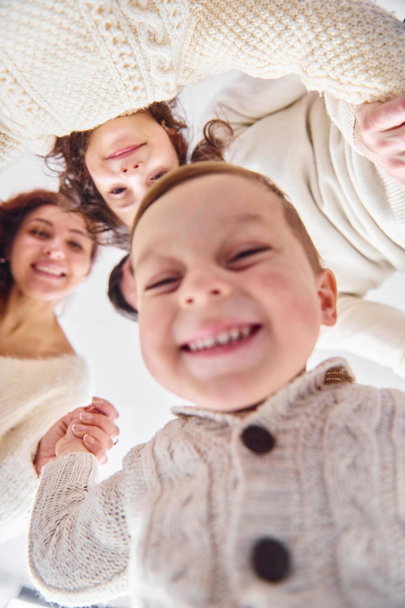 Smiling and having fun. View from below. Happy family looking down Stock Free