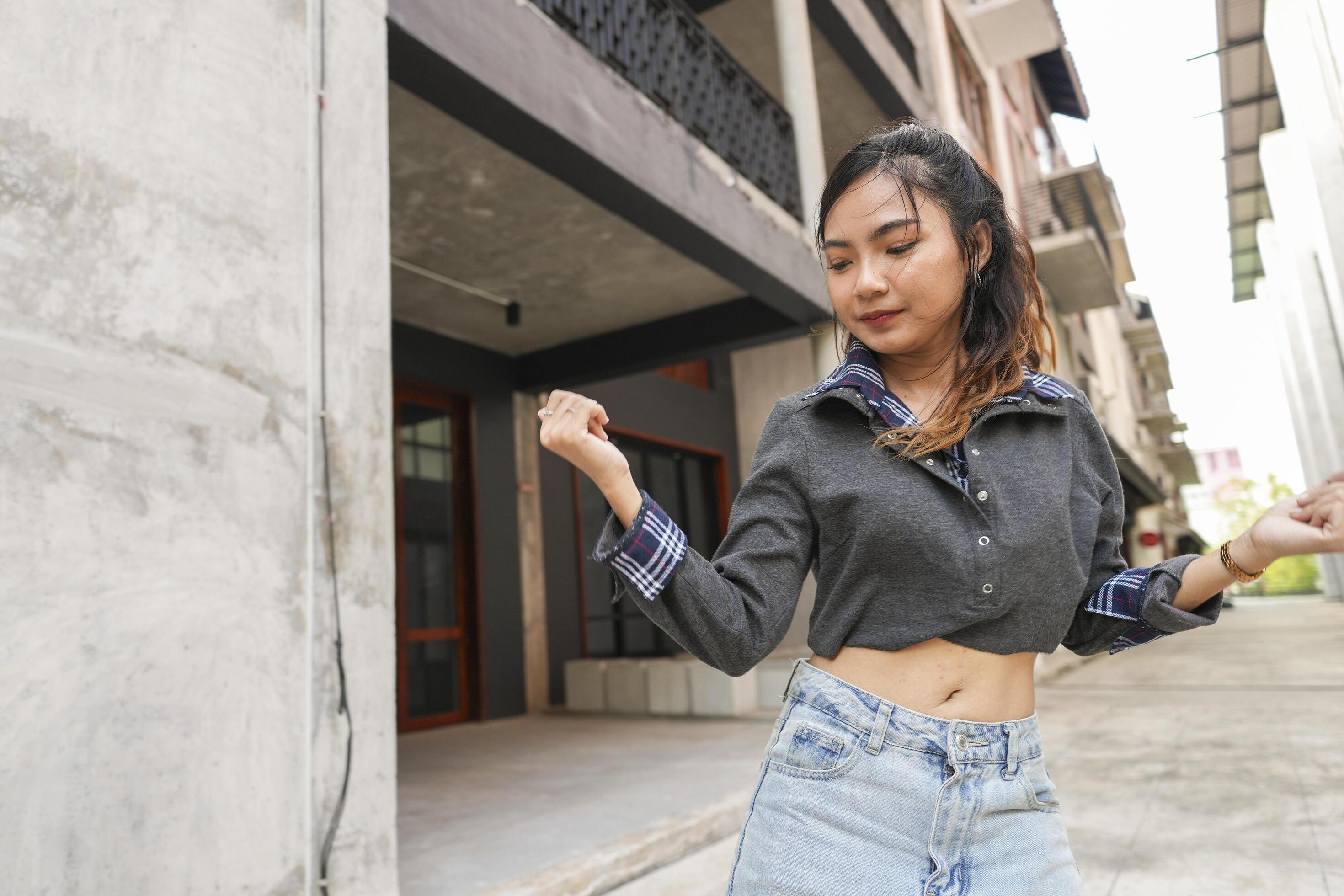 Asian women do freestyle hip hop and breakdancing in a public space in the middle of the city. With a cheerful and happy attitude Stock Free