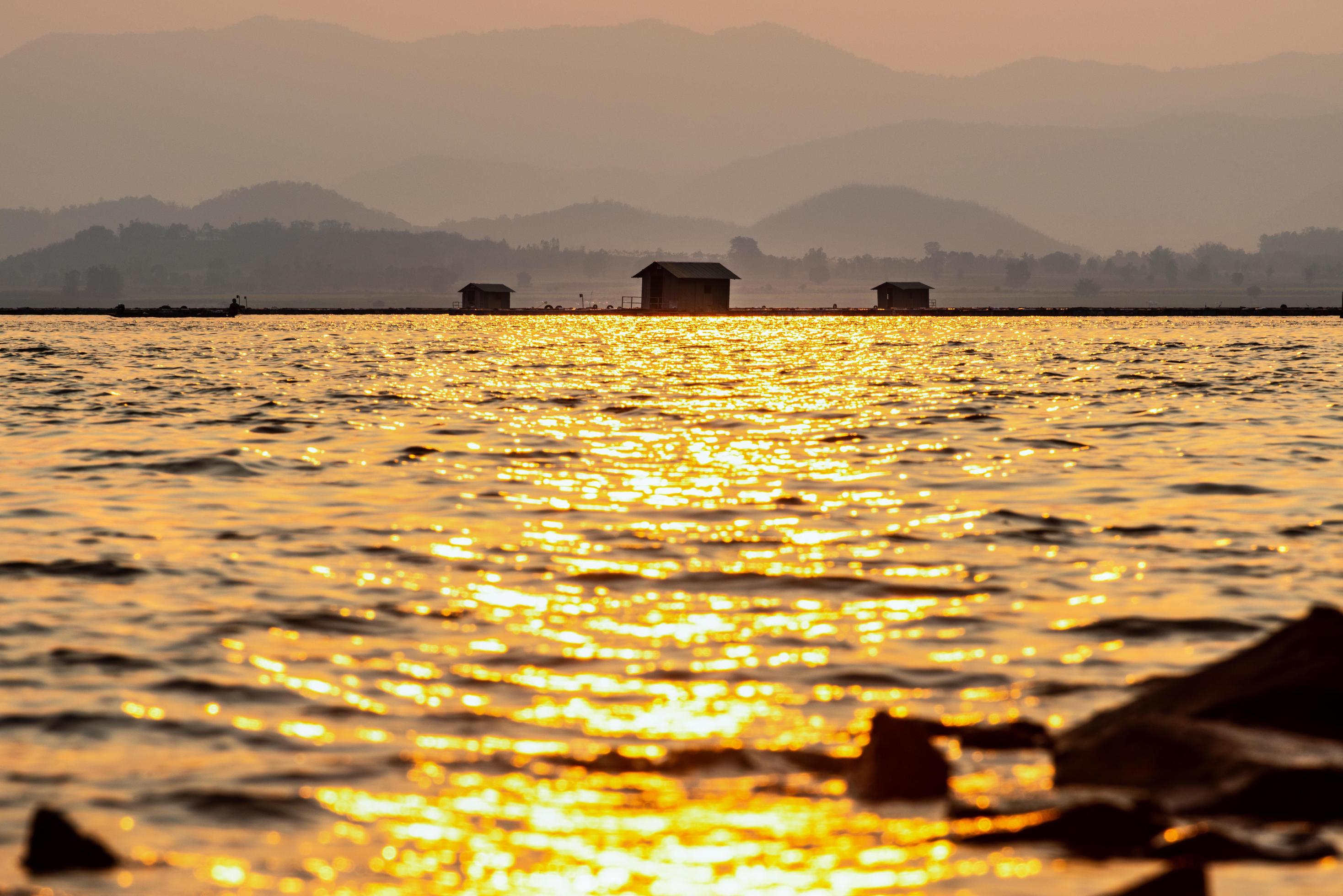 Silhouette fish farming cages in a rural lifestyle Stock Free