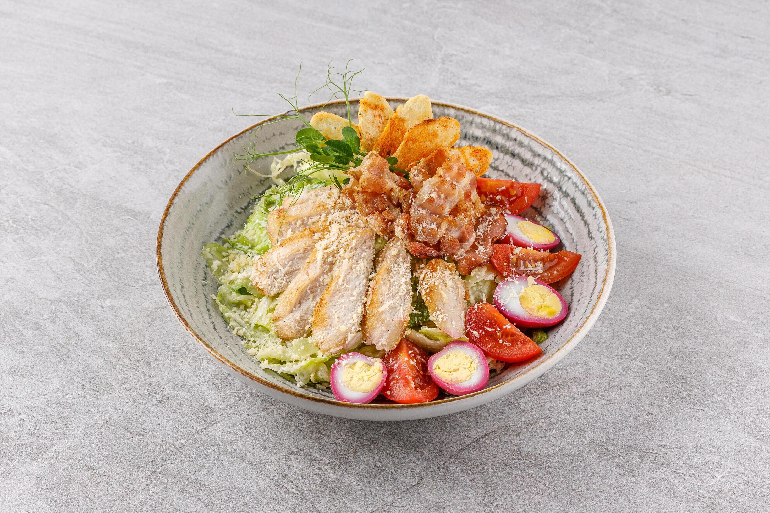 Caesar salad with chicken and bacon on a stone background studio food photo 8 Stock Free