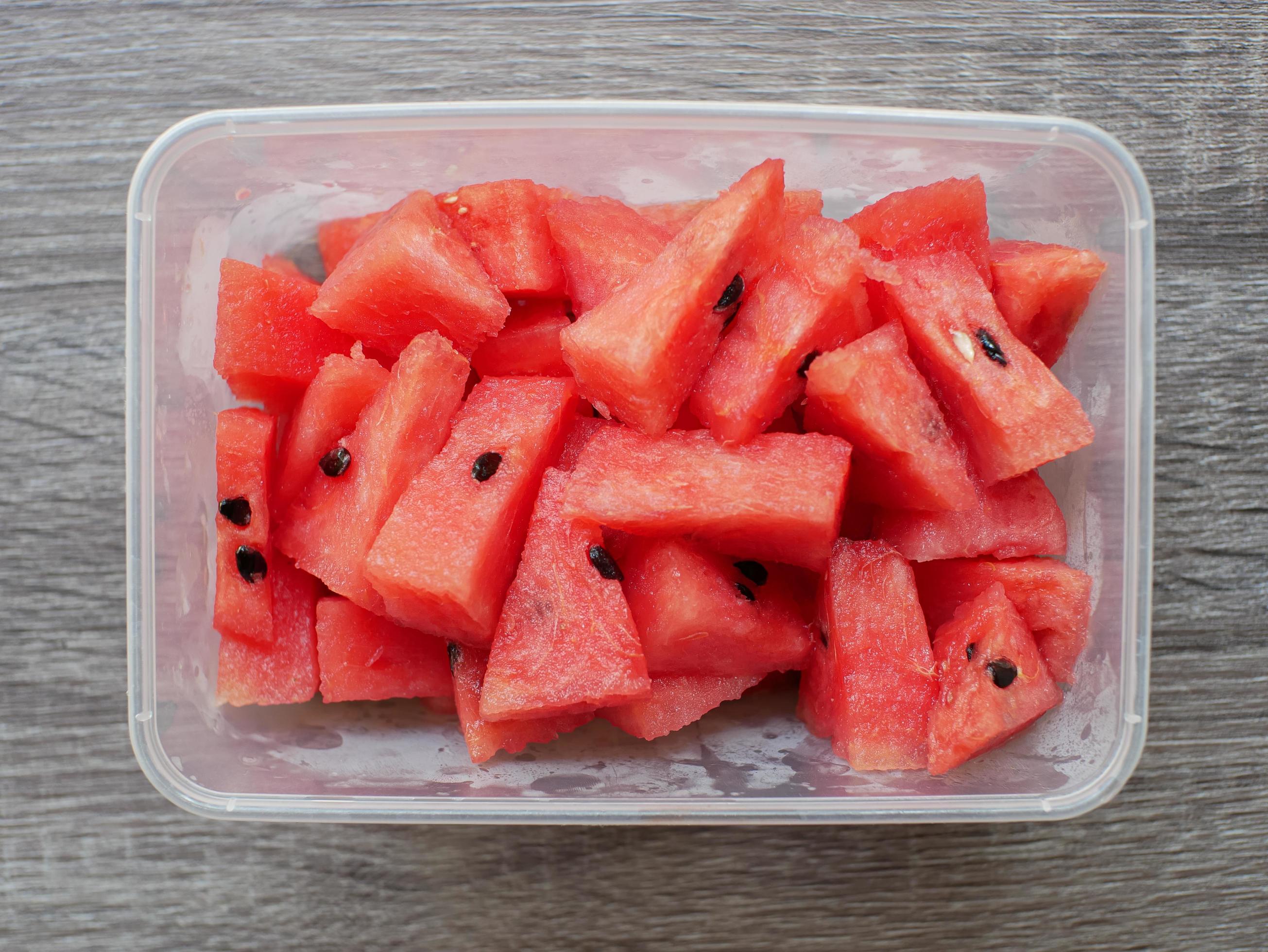 sliced fresh watermelon in a transparent container. healthy food and diet concept Stock Free