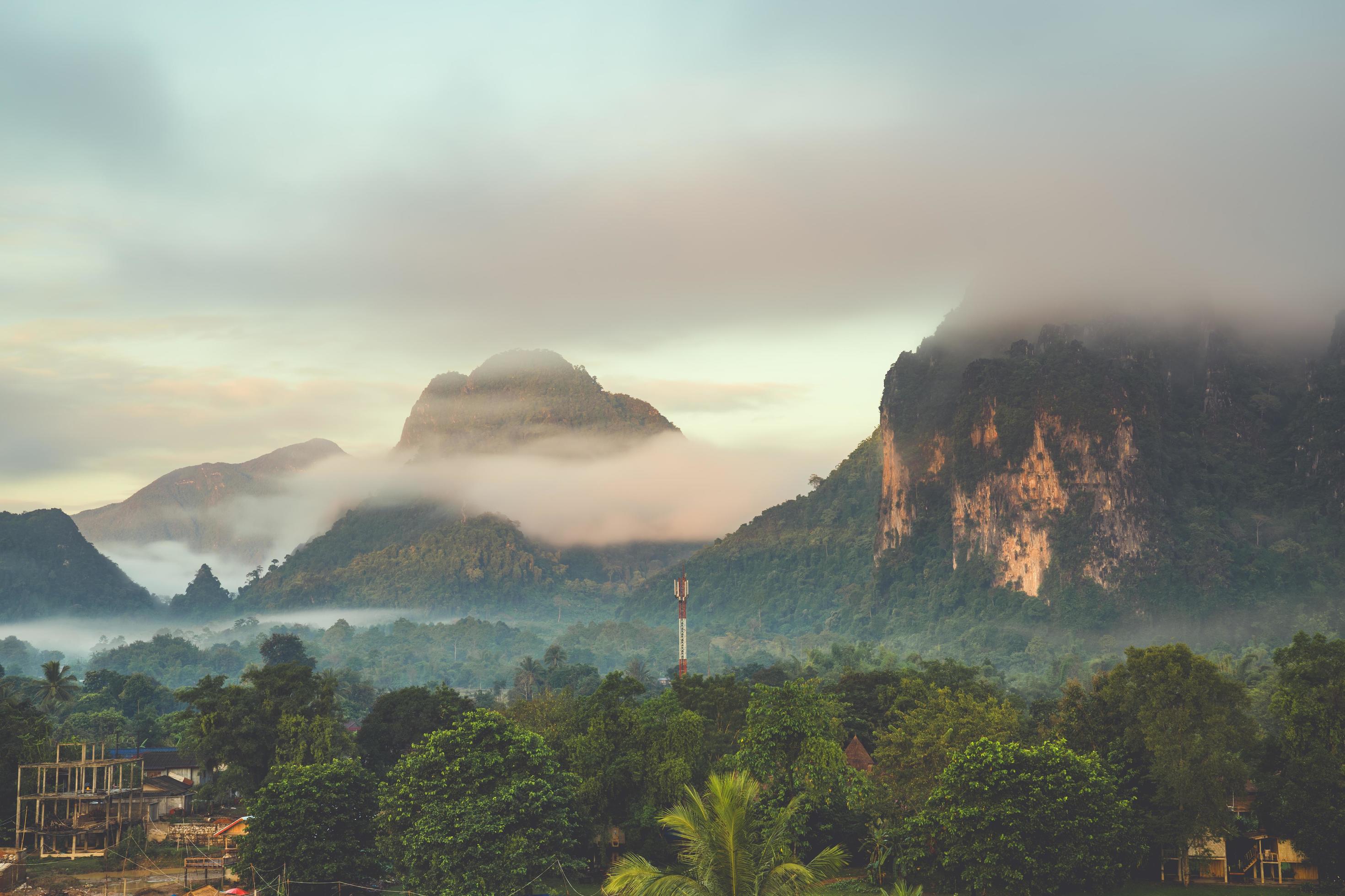 Beautiful sunrise and white mist with mountain at Vang vieng, Laos. Stock Free