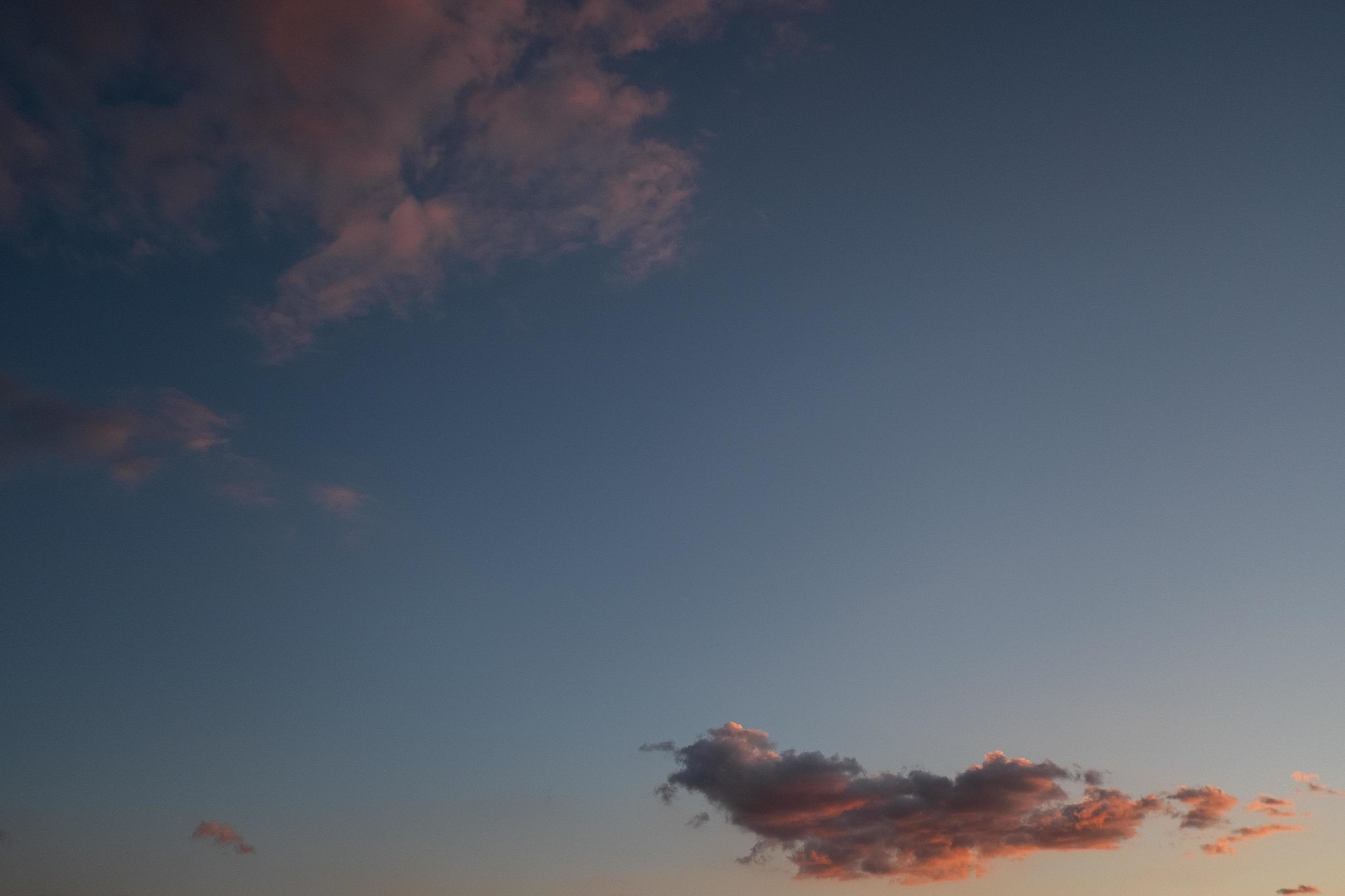 Pink clouds in blue sky Stock Free