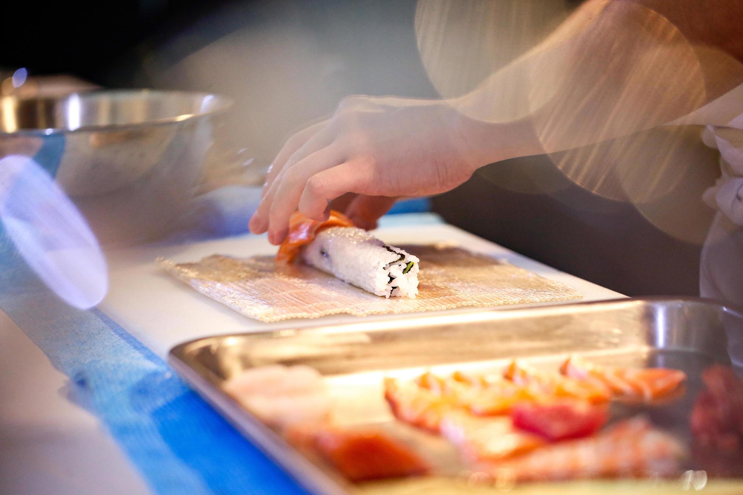 chef hands preparing japanese food, chef making sushi Stock Free