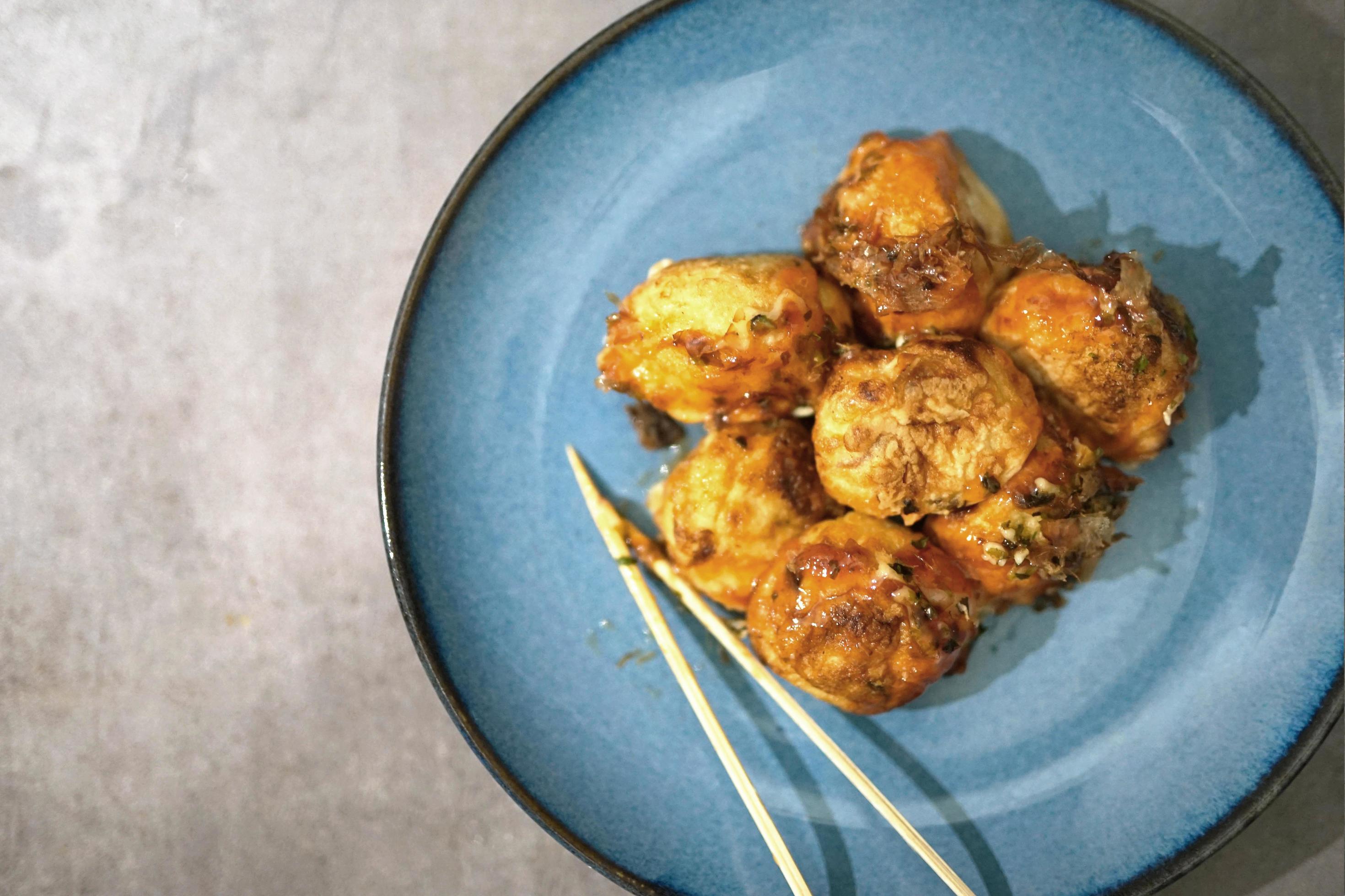 traditional japanese food, takoyaki with sauce on a blue plate Stock Free