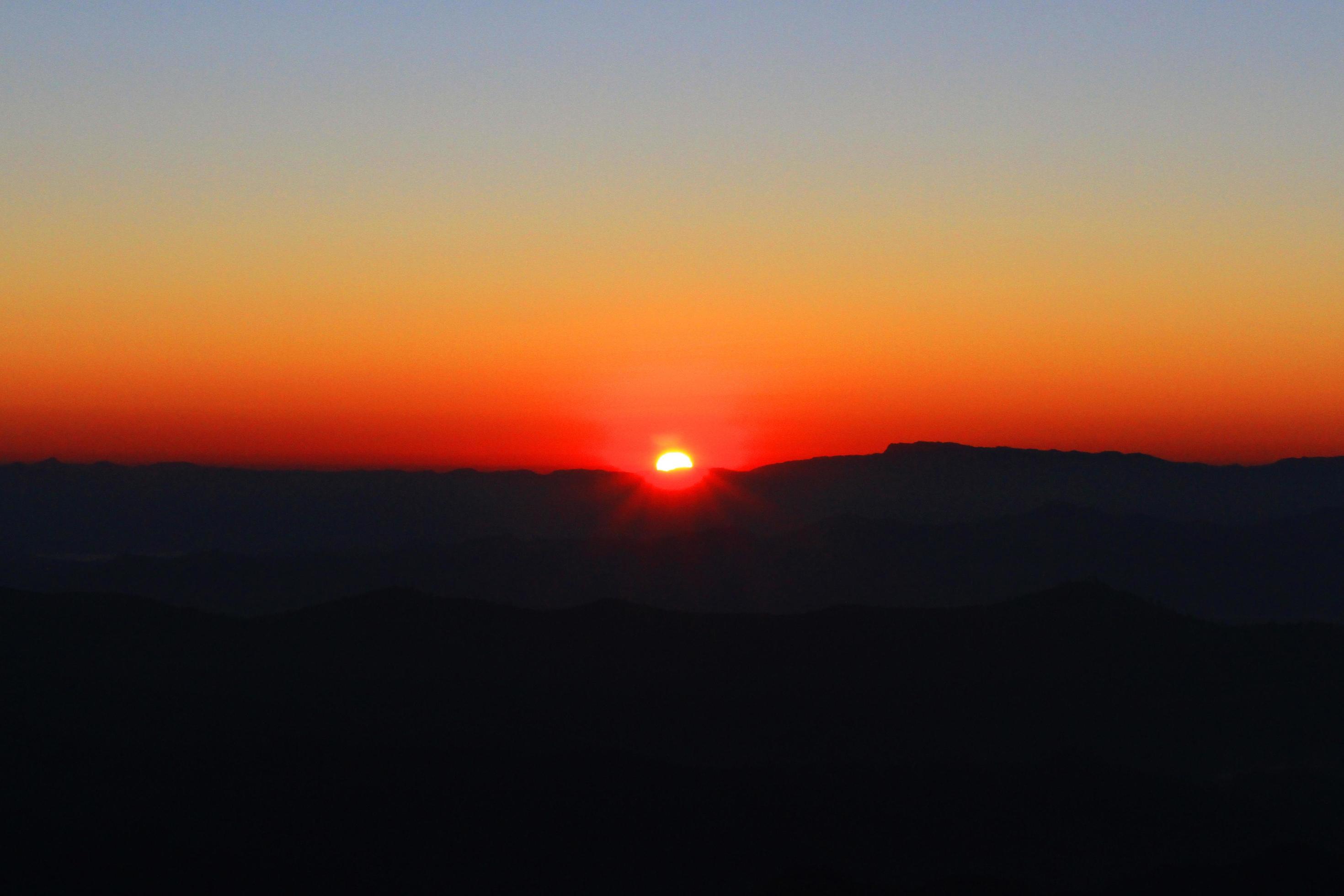 Sunset in sky and cloud, beautiful colorful twilight time with silhouette of mountain. Stock Free