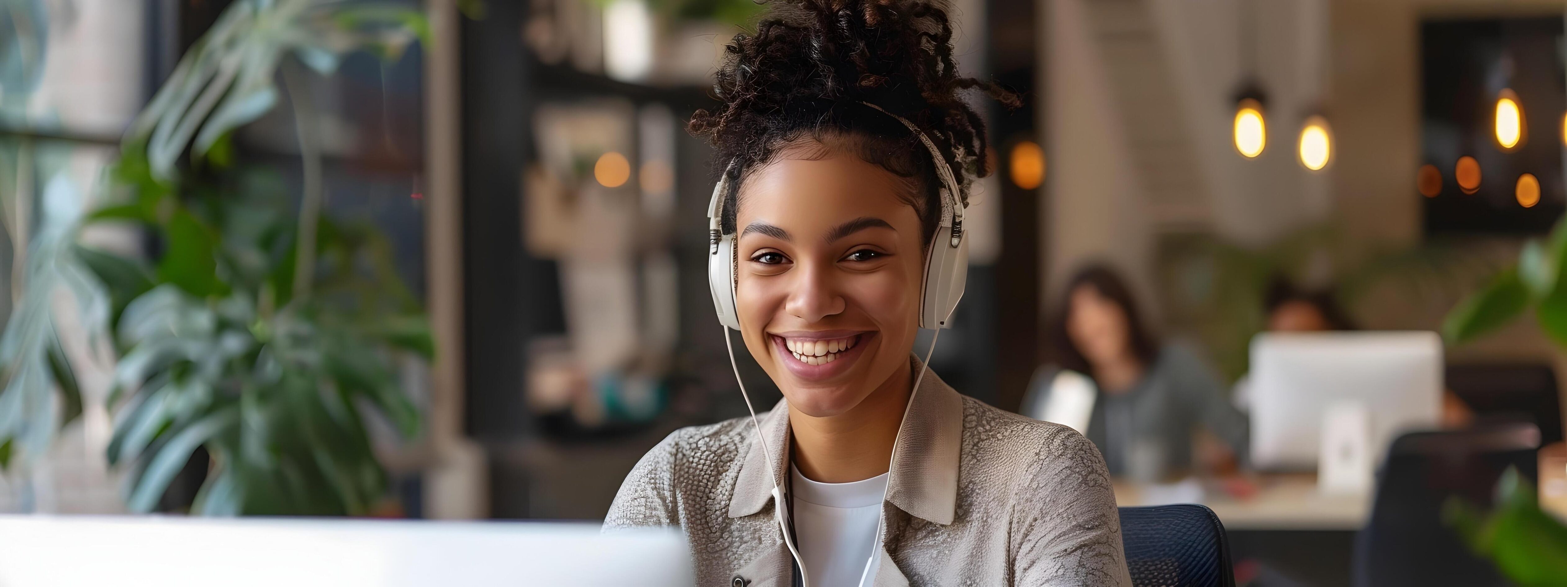 Confident Young Account Representative Smiling and Working at Desk in Modern Office Stock Free