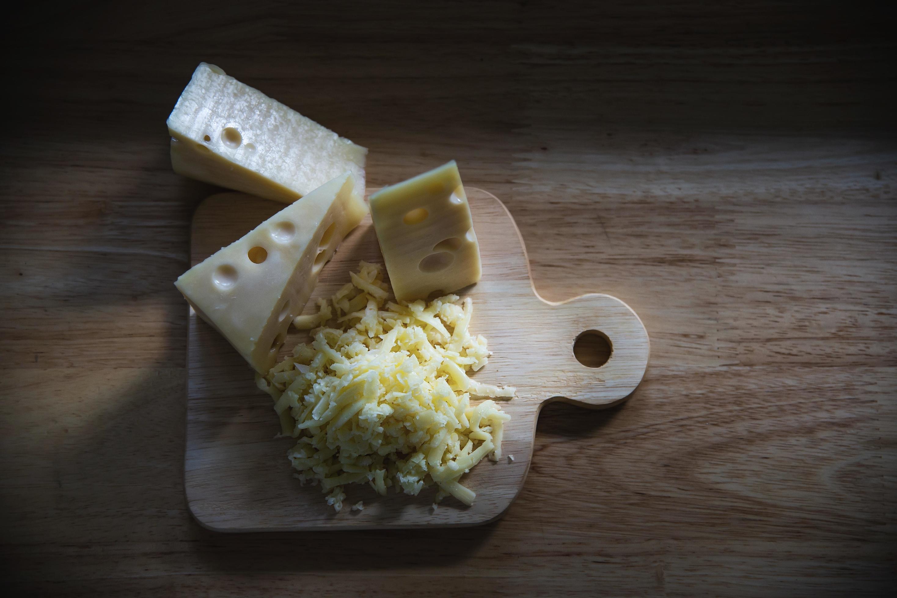 Beautiful cheeses in the kitchen – cheese food preparing concept Stock Free