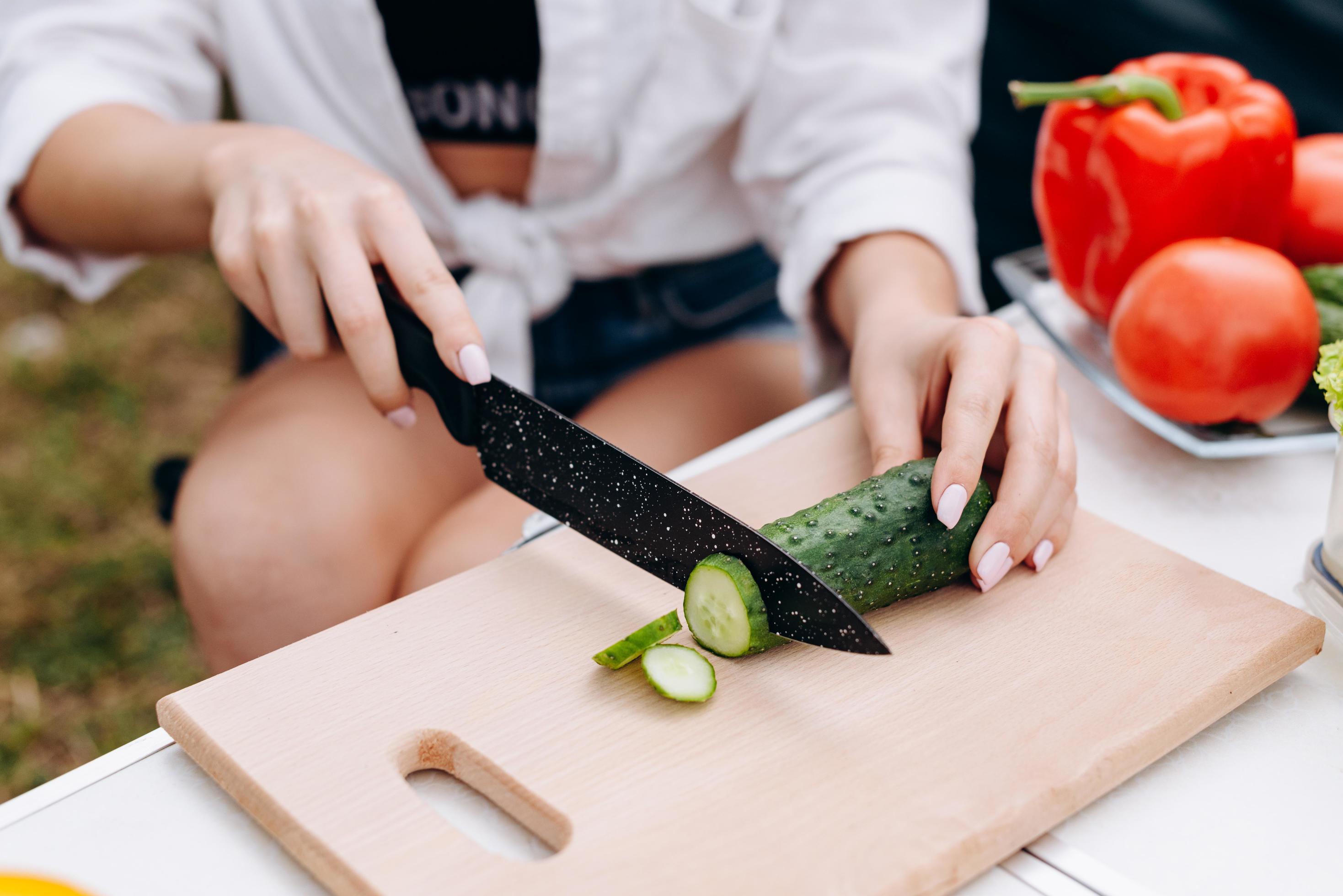 Closeup female hands during preparing food outdoor in the camping Stock Free