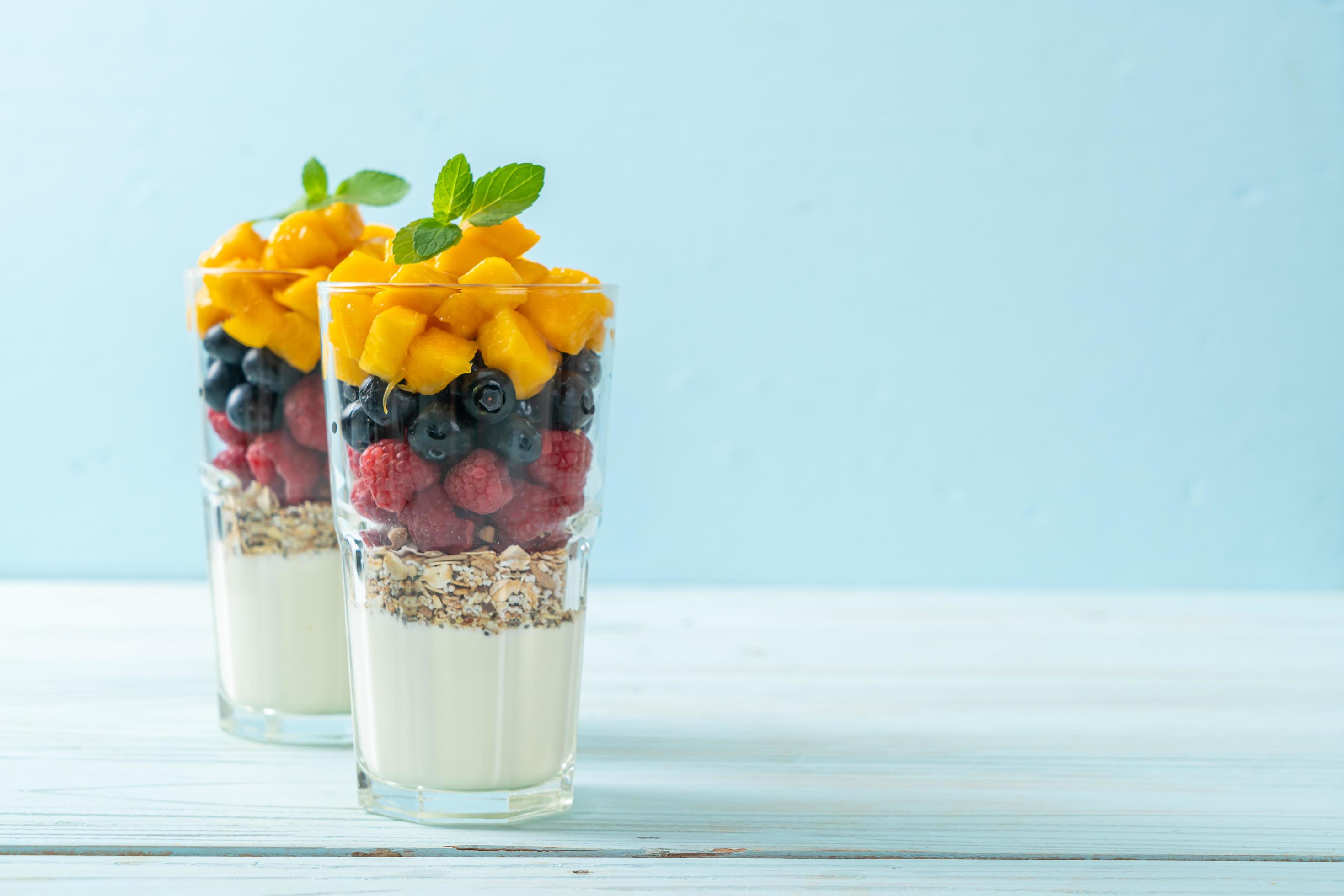 Homemade mango, raspberry, and blueberry with yogurt and granola – healthy food style Stock Free