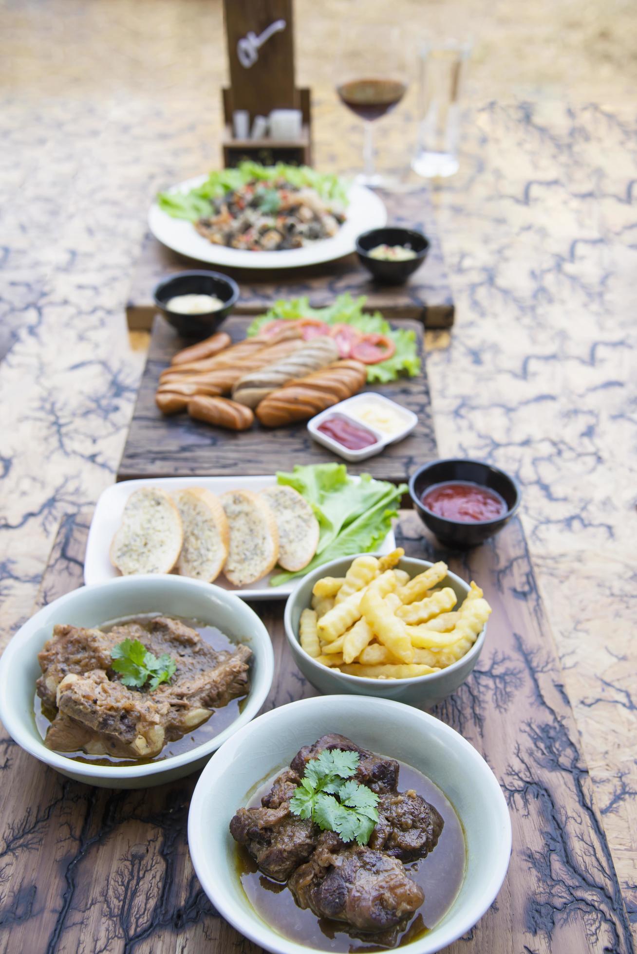 Beef and pork stew with French fries and others food recipes on wooden table, food meal preparing ready for eat concept Stock Free