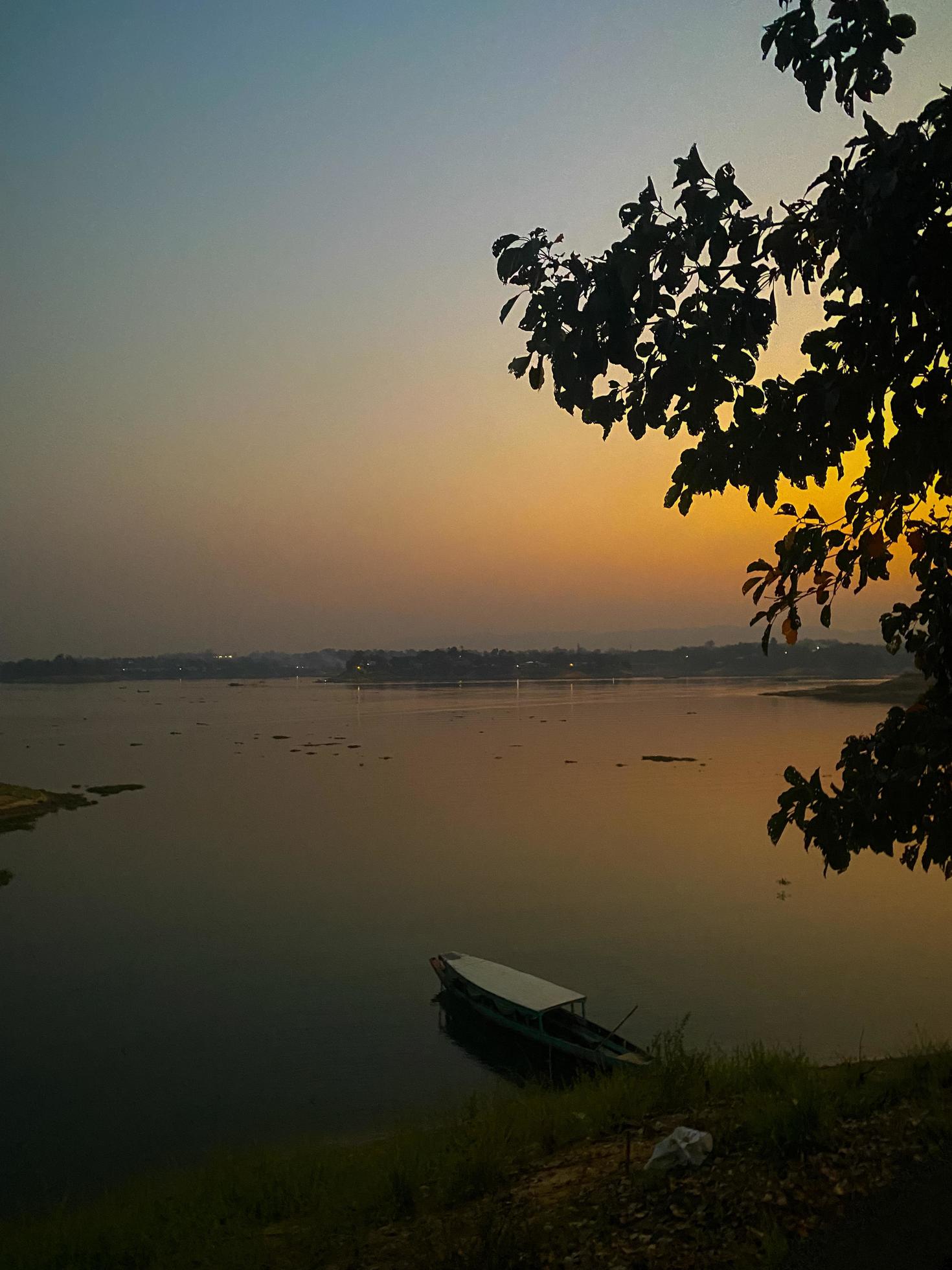 A boat is in the water at sunset Stock Free