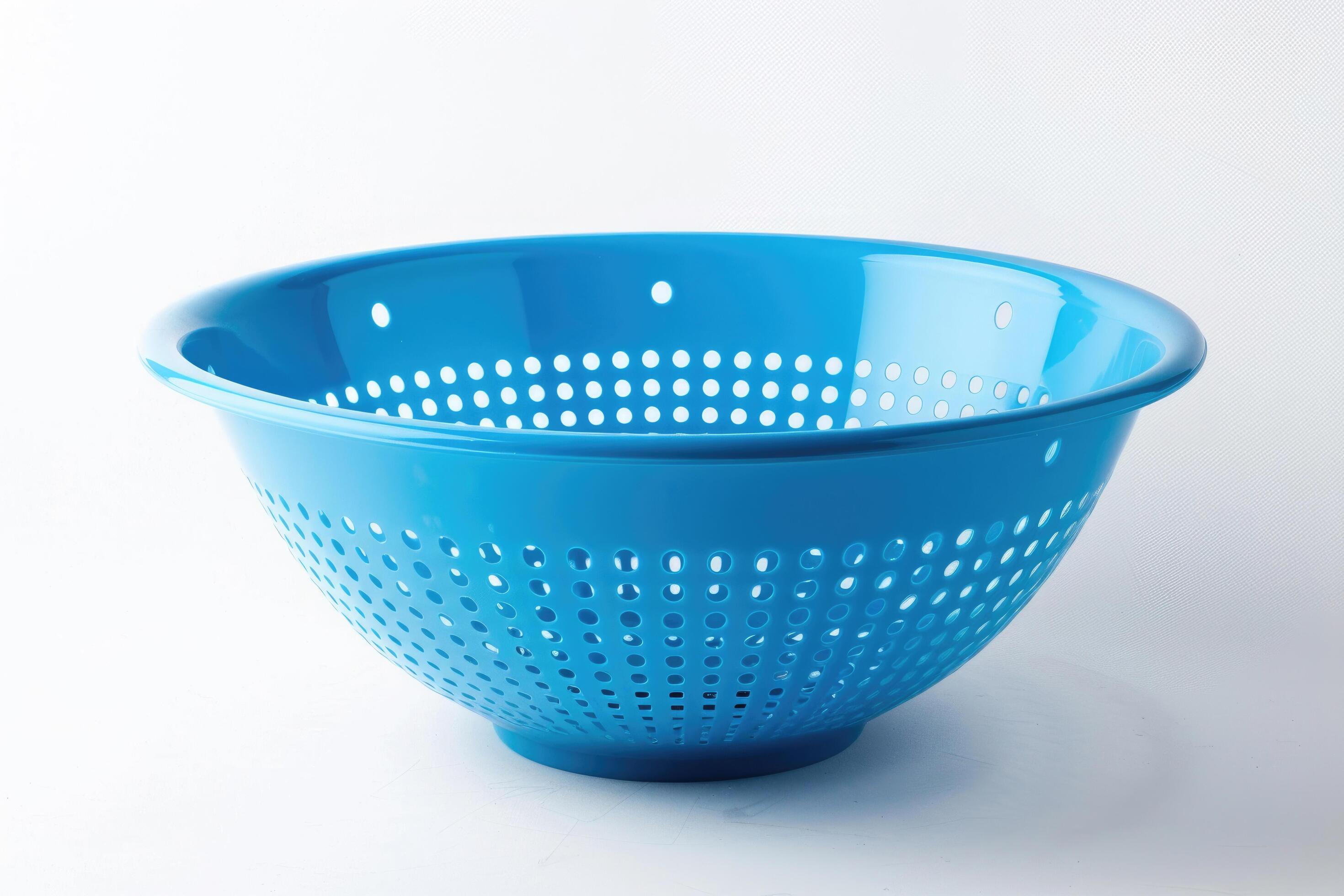 Blue plastic colander on a white background. Stock Free