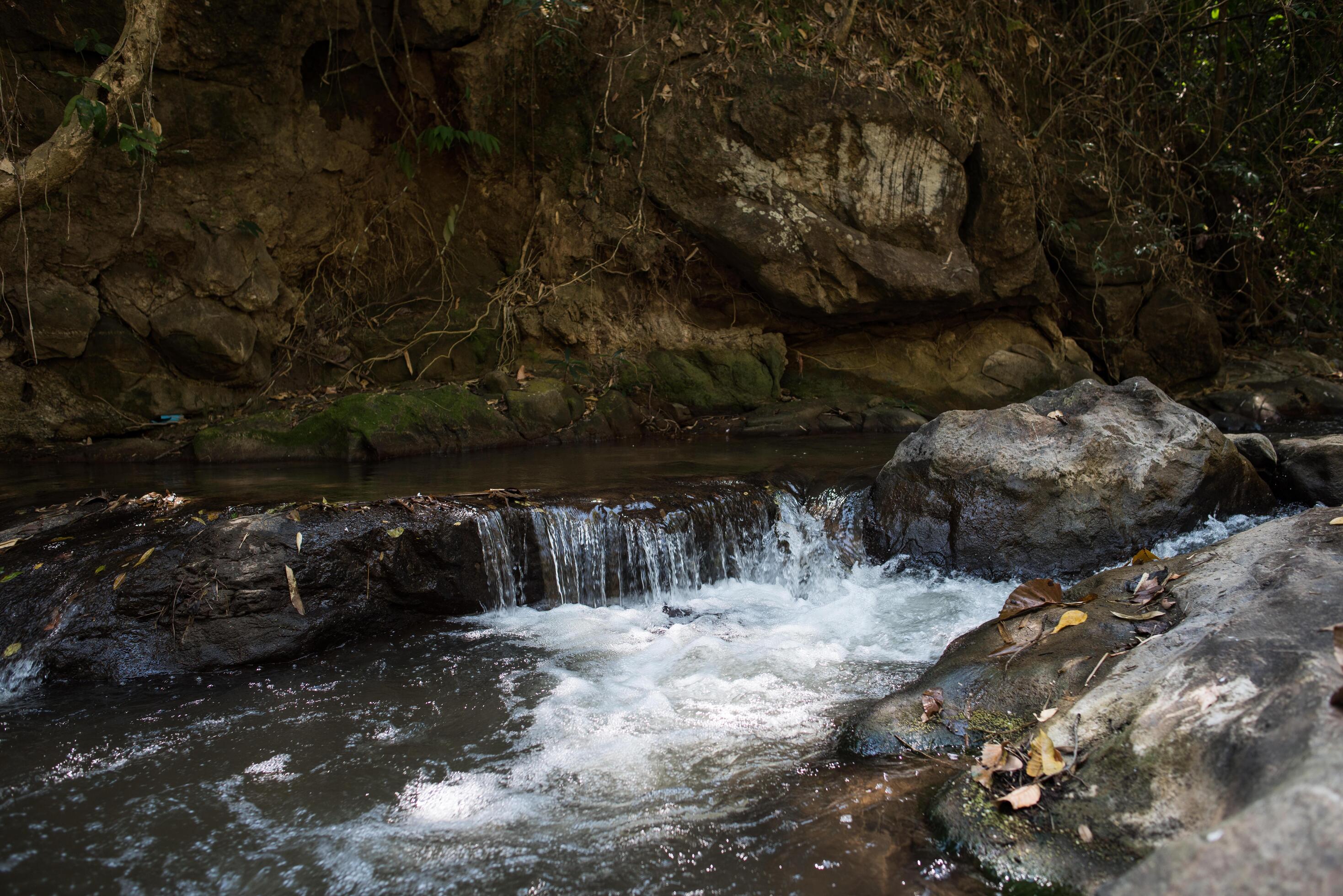 Waterfall in the nature and stone background Stock Free