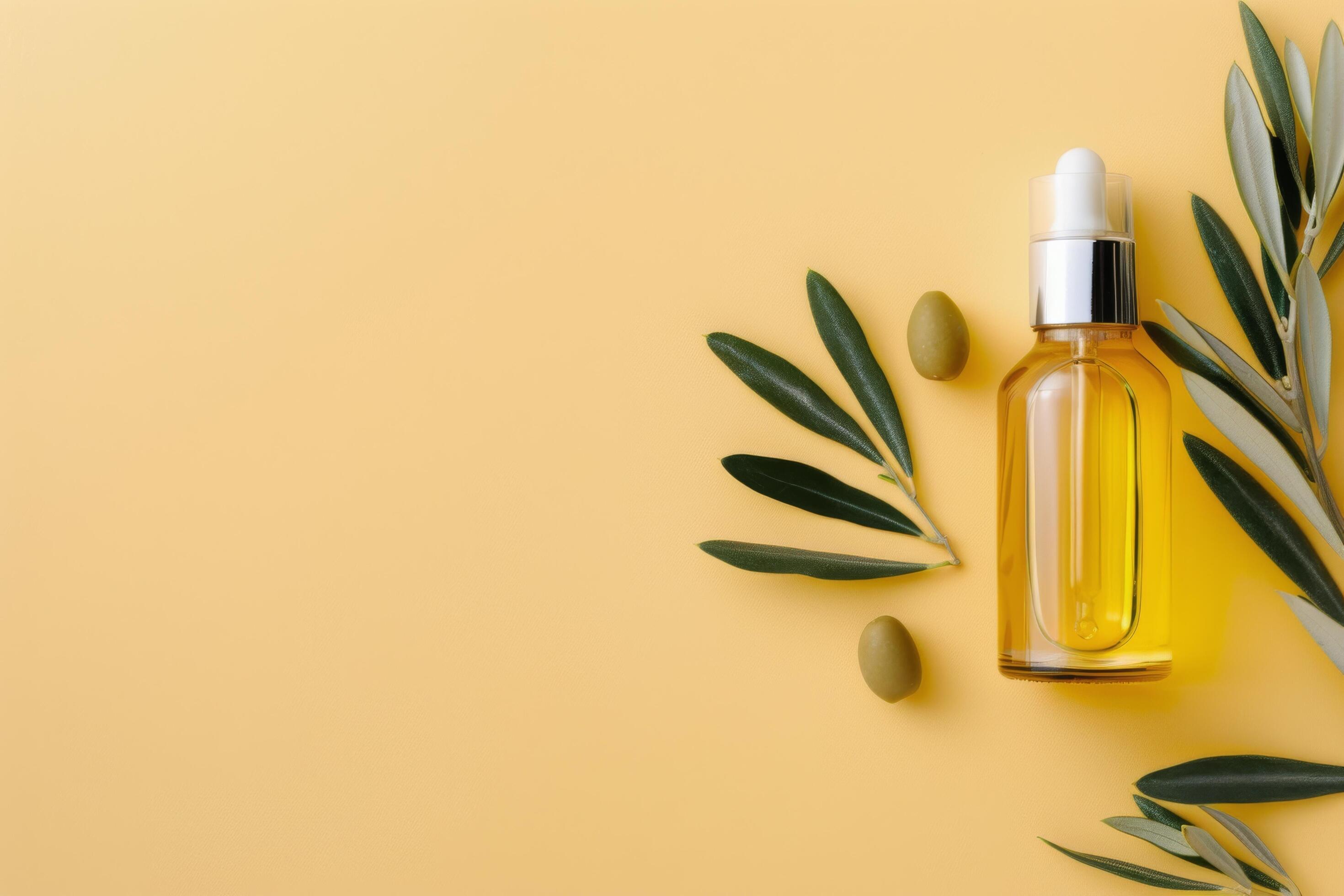 Olive Oil Bottle With Leaves on Yellow Background Stock Free